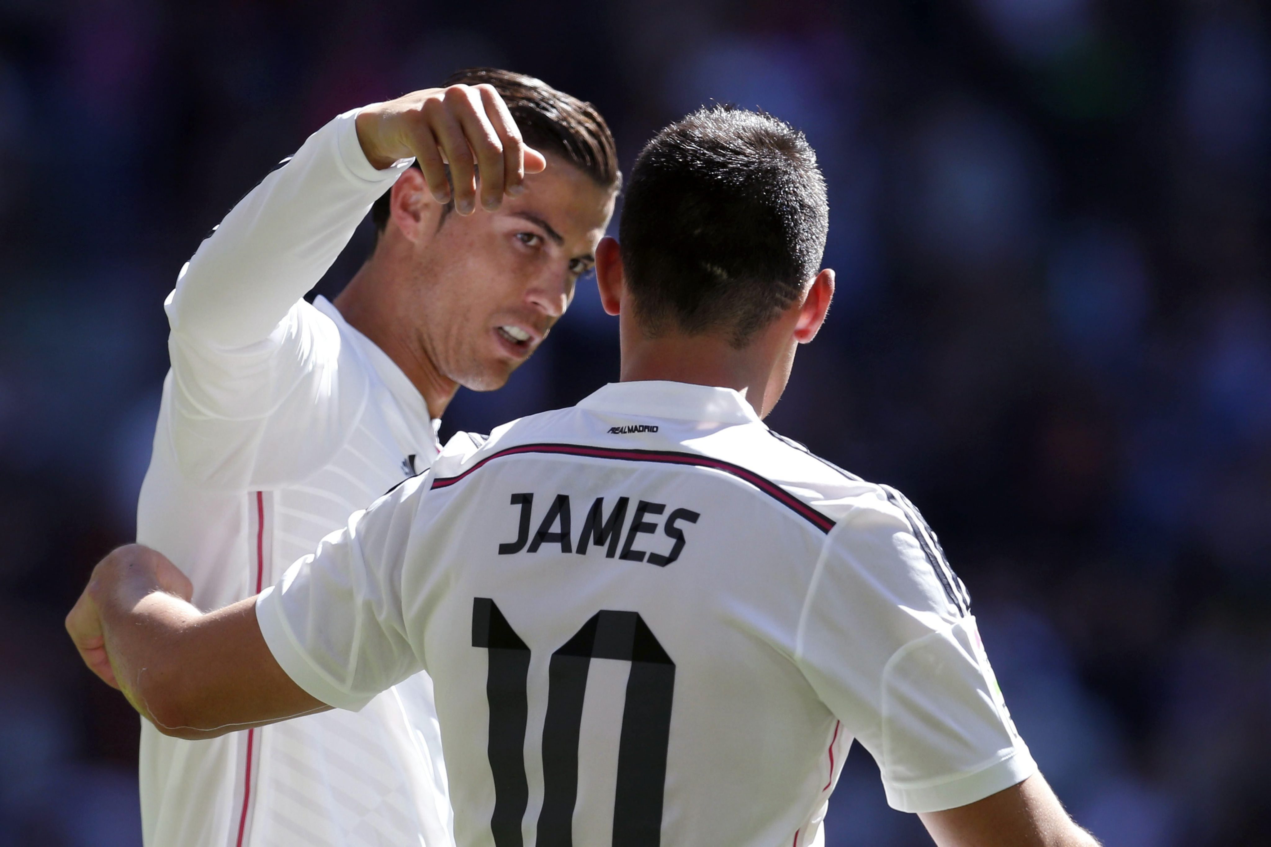 Real Madrid's Portuguese forward Cristiano Ronaldo celebrates a goal against Granada with teammate James Rodriguez (R) during the Primera Division match Real Madrid vs Granada at the Santiago Bernabeu stadium in Madrid, Spain, 05 April 2015. (Photo by Juan Carlos Hidalgo/EPA)