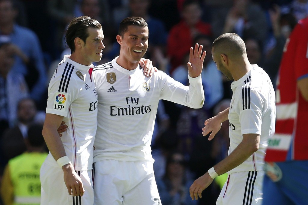 Real Madrid's forward Portuguese Cristiano Ronaldo (C) celebrates a goal against Granada with teammates Gareth Bale (L) and Karim Benzema (R) during the Primera Division match Real Madrid vs Granada at the Santiago Bernabeu stadium in Madrid, Spain, 05 April 2015. (Photo by Juan Carlos Hidalgo/EPA)