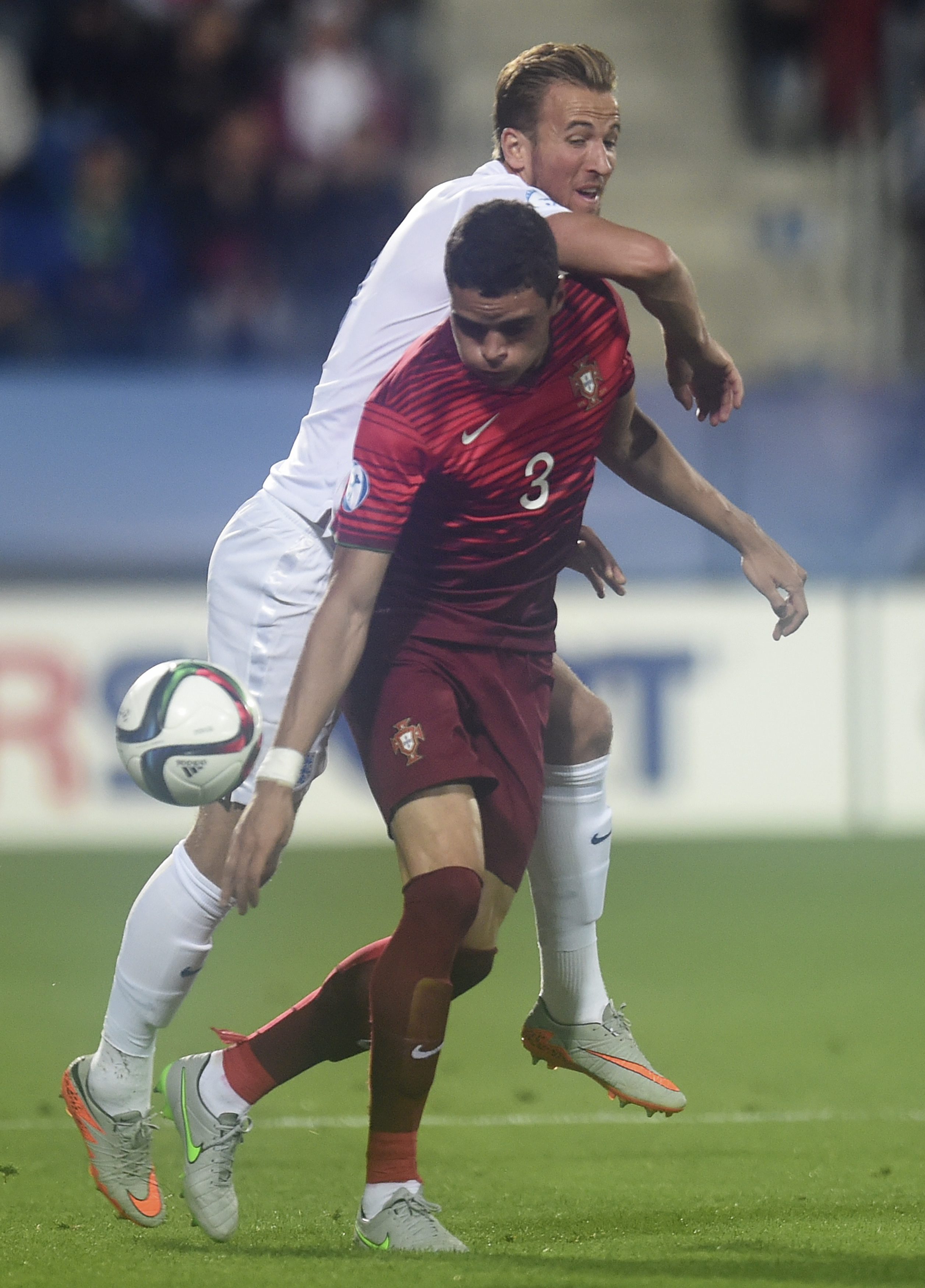 English player Harry Kane (back) vies for the ball with Portuguese player Tiago Ilori (R) during UEFA European Under-21 soccer championship match between England and Portugal at the City Stadium in Uherske Hradiste, Czech Republic on 18 June 2015