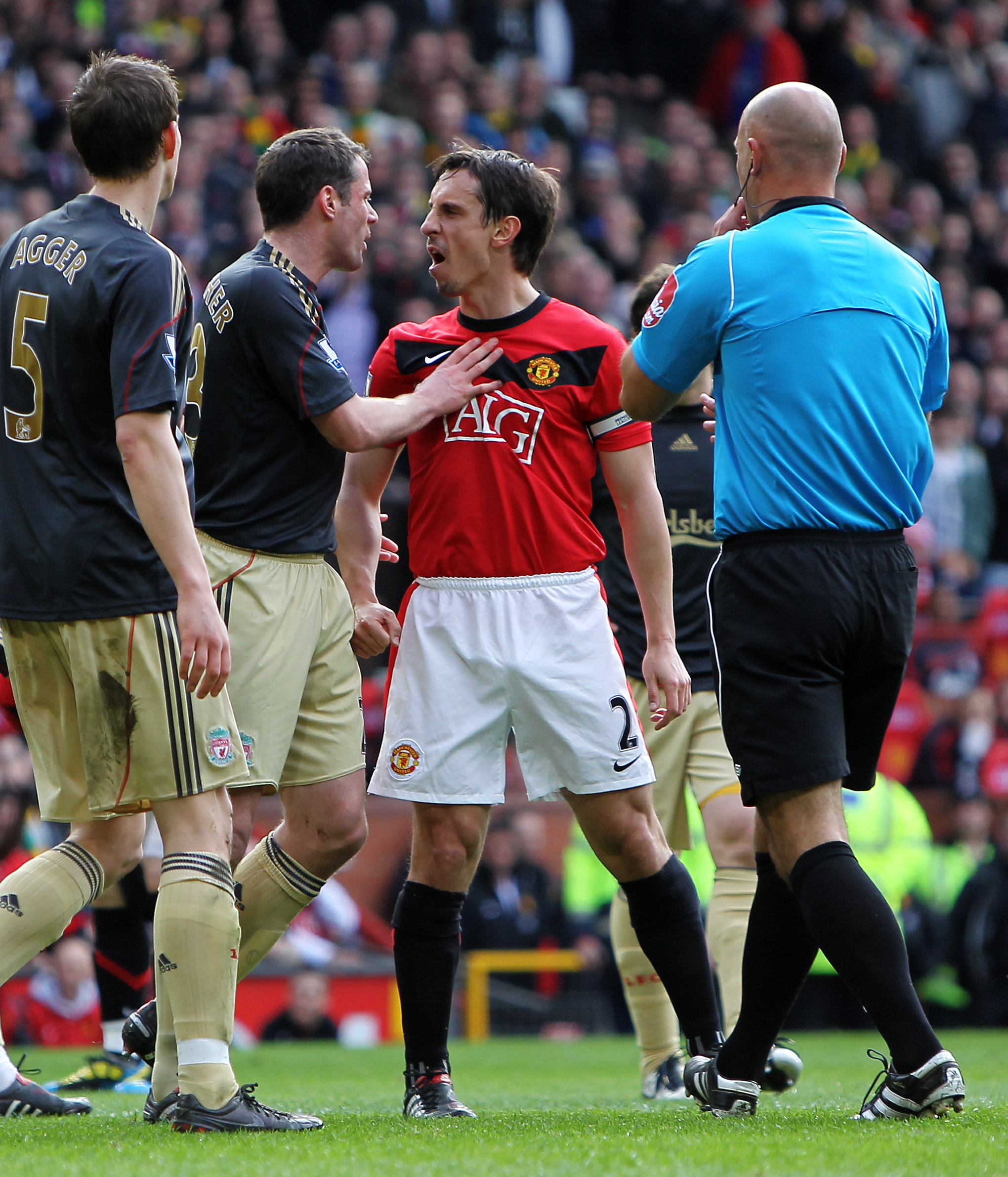 epa02087839 Liverpool's Jamie Carragher (2L) argues with Manchester United's Gary Neville (2R) during today's English Barclays Premier League soccer match between Manchester United FC and Liverpool FC, at the Old Trafford stadium, Manchester, Britain, Sunday 21 March 2010. EPA/MAGI HAROUN UK AND IRELAND OUT