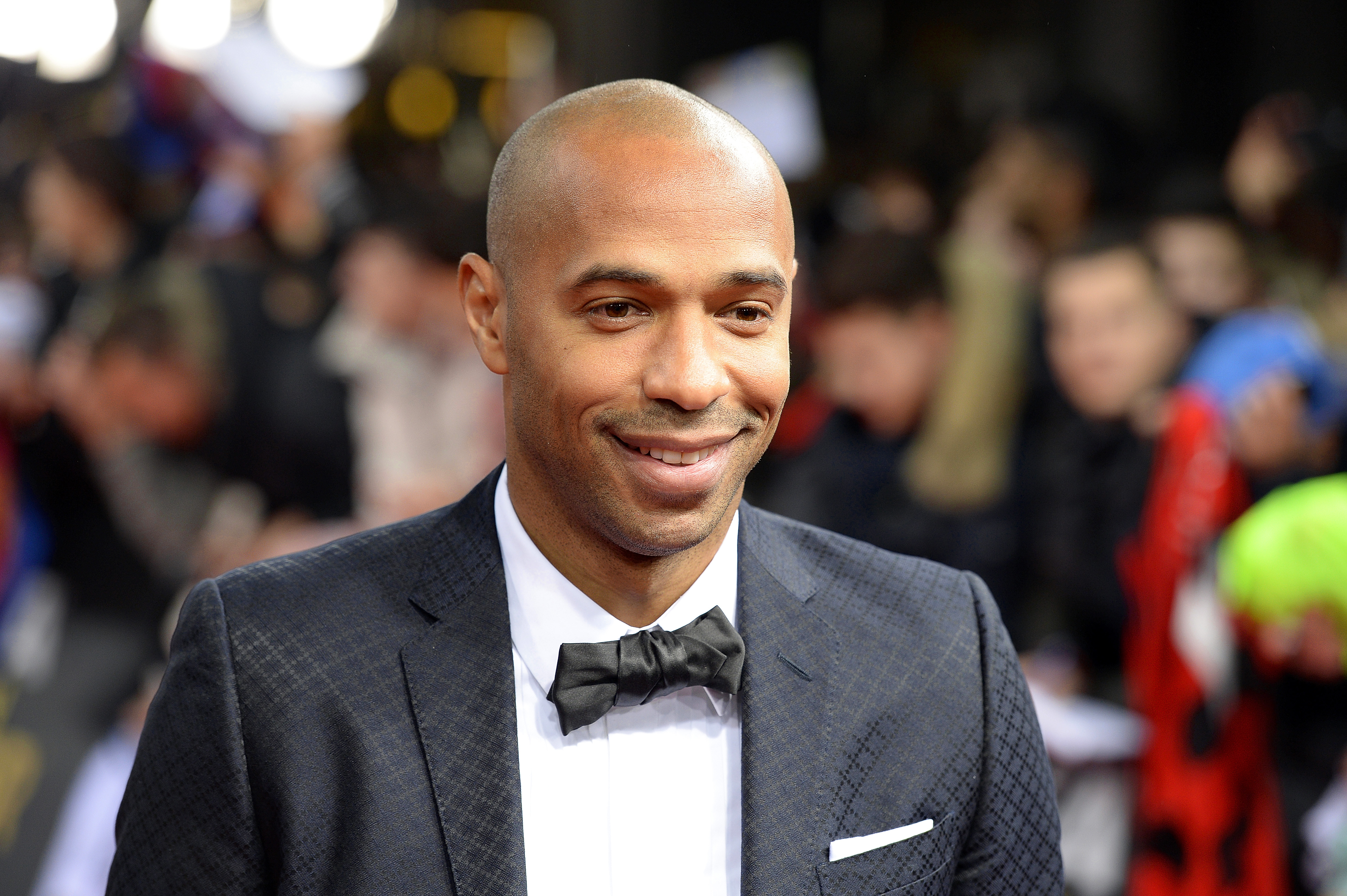 epa04557439 Former French soccer player Thierry Henry arrives on the red carpet prior to the FIFA Ballon d'Or 2014 gala held at the Kongresshaus in Zurich, Switzerland, 12 January 2015. EPA/WALTER BIERI