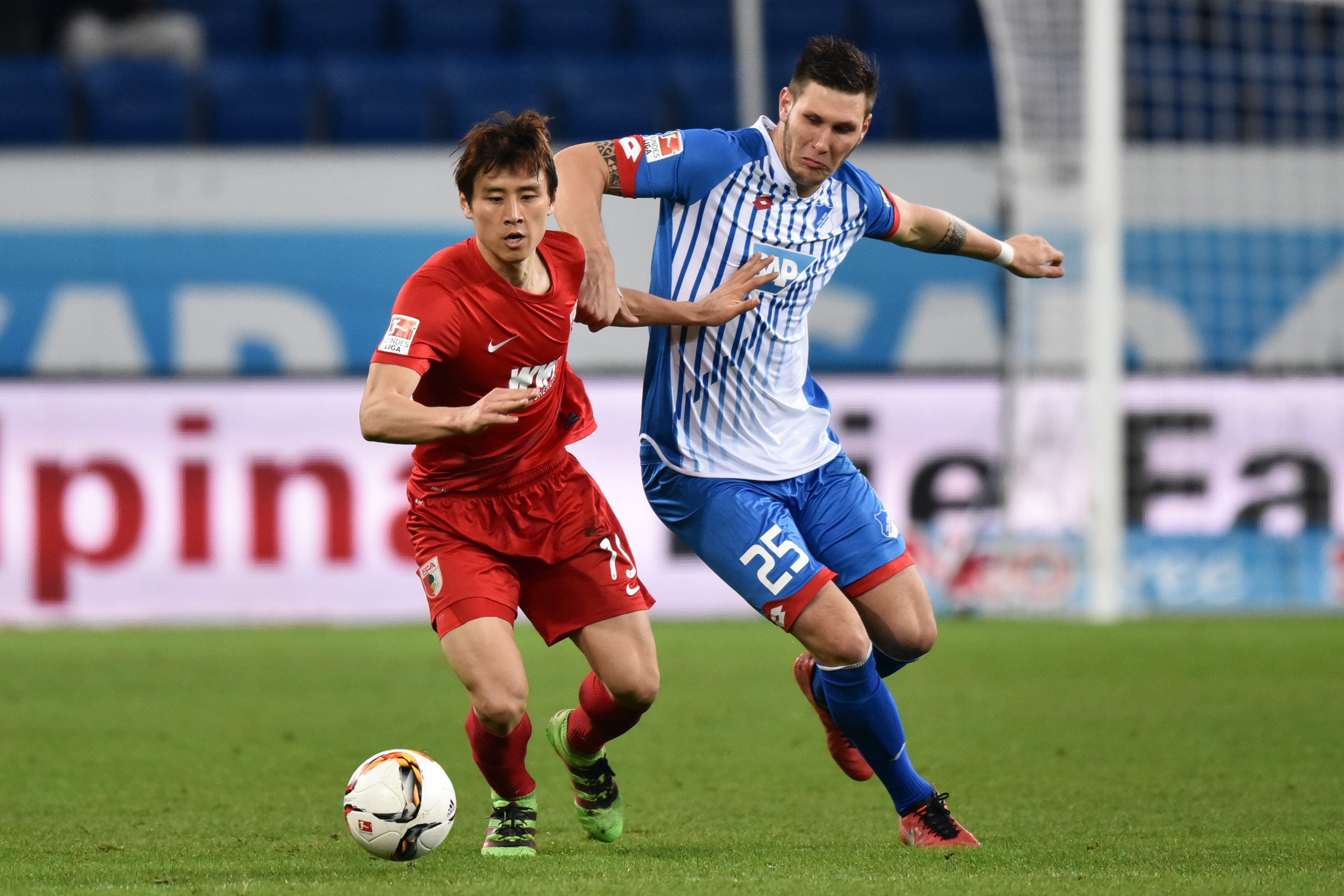 Hoffenheims Niklas Süle (R) and FC Augsburg Ja-Cheol Koo fight for the ball during the German Bundesliga match between Hoffenheim and Augsburg in Hoffenheim, Germany 02 March 2016.  (Photo by Uwe Anspach/EPA)