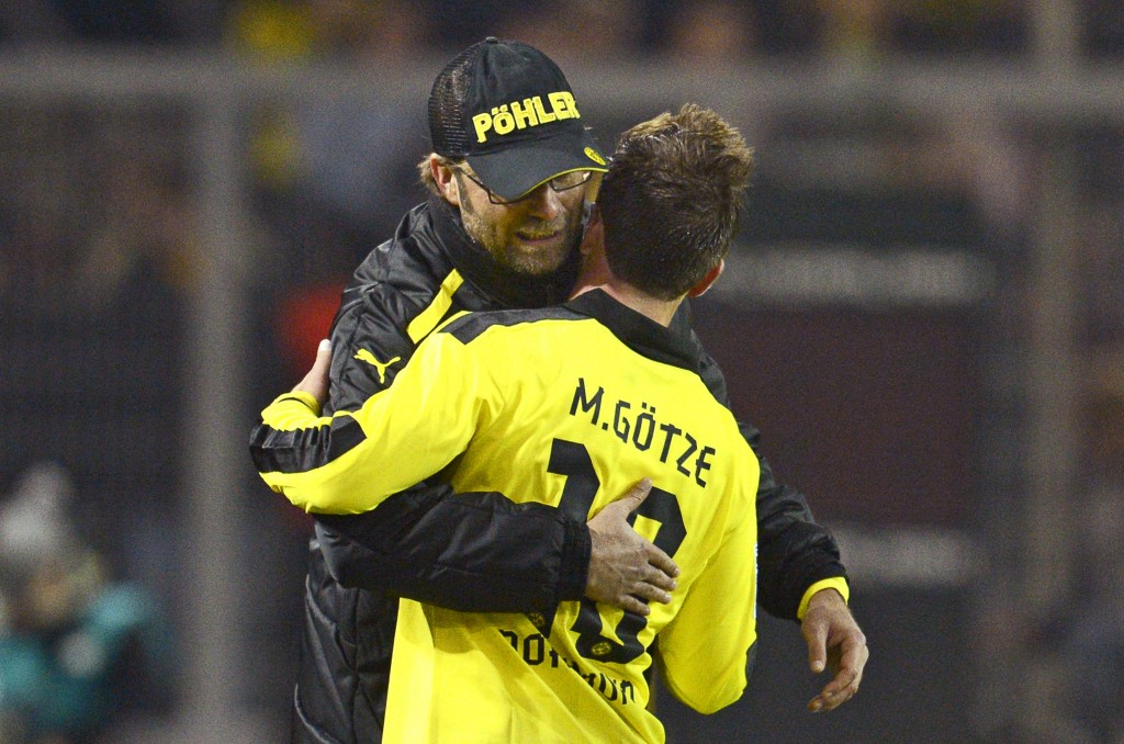 epa03475207 Dortmund's head coach Juergen Klopp (L) celebrates with Mario Goetze (R) during the German Bundesliga soccer match between Borussia Dortmund and SpVgg Greuther Fuerth in Dortmund, Germany, 17 November 2012. Dortmund won 3-1. (ATTENTION: EMBARGO CONDITIONS! The DFL permits the further utilisation of up to 15 pictures only (no sequential pictures or video-similar series of pictures allowed) via the internet and online media during the match (including halftime), taken from inside the stadium and/or prior to the start of the match. The DFL permits the unrestricted transmission of digitised recordings during the match exclusively for internal editorial processing only (e.g. via picture databases) EPA/BERND THISSEN
