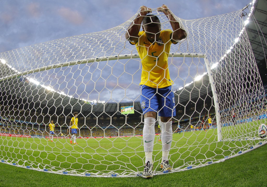 epa04448642 YEARENDER 2014 JULY Fernandinho of Brazil react after a goal scored by Toni Kroos of Germany during the FIFA World Cup 2014 semi final match between Brazil and Germany at the Estadio Mineirao in Belo Horizonte, Brazil, 08 July 2014. (RESTRICTIONS APPLY: Editorial Use Only, not used in association with any commercial entity - Images must not be used in any form of alert service or push service of any kind including via mobile alert services, downloads to mobile devices or MMS messaging - Images must appear as still images and must not emulate match action video footage - No alteration is made to, and no text or image is superimposed over, any published image which: (a) intentionally obscures or removes a sponsor identification image; or (b) adds or overlays the commercial identification of any third party which is not officially associated with the FIFA World Cup) EPA/ROBERT GHEMENT EDITORIAL USE ONLY