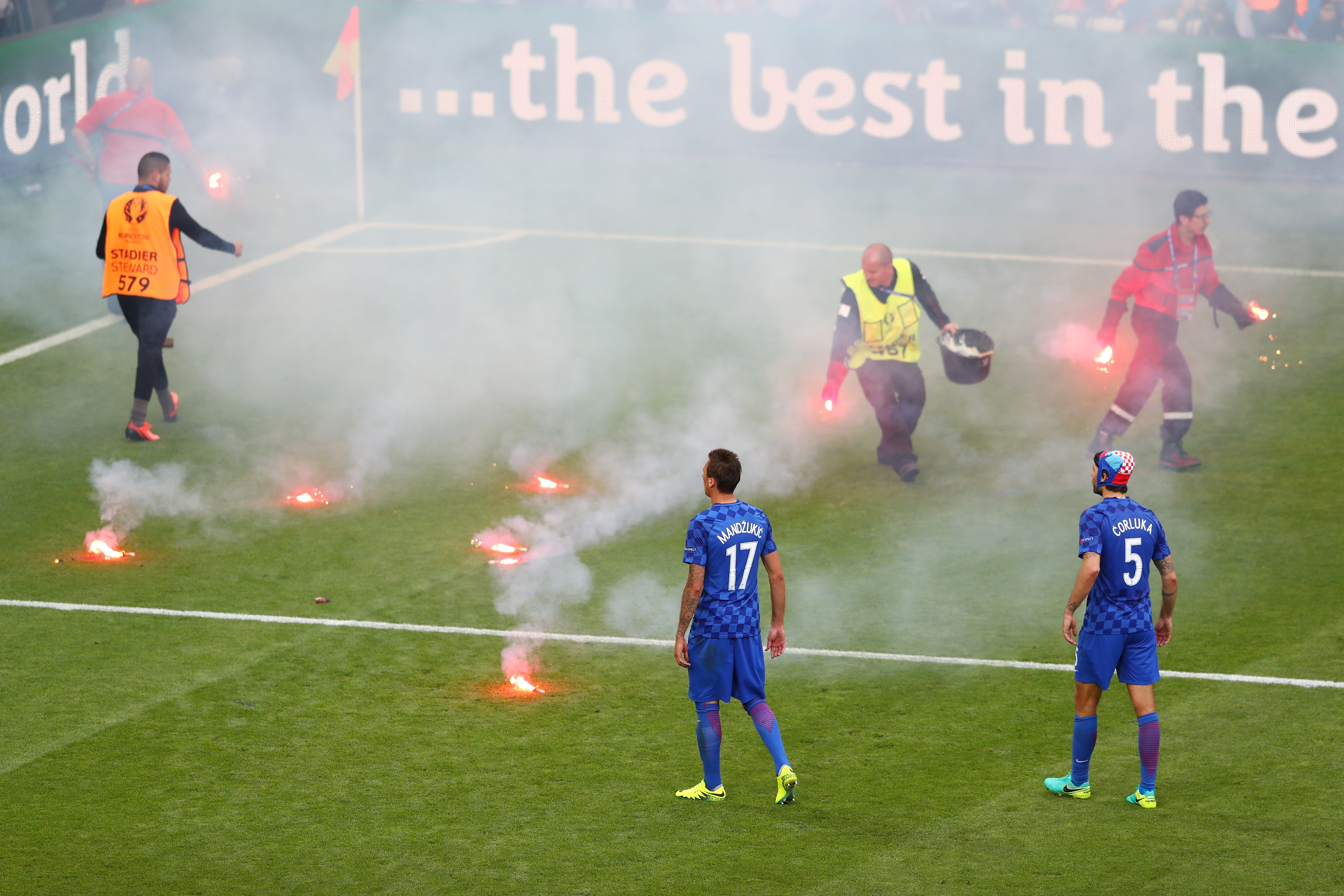 SAINT-ETIENNE, FRANCE - JUNE 17: Mario Mandzukic of Croatia and Vedran Corluka of Croatia look on as fire marshal's take flares from the pitch during the UEFA EURO 2016 Group D match between Czech Republic and Croatia at Stade Geoffroy-Guichard on June 17, 2016 in Saint-Etienne, France. (Photo by Michael Steele/Getty Images)
