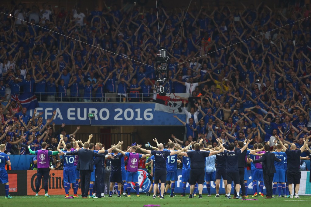 NICE, FRANCE - JUNE 27: Iceland players celebrate their team's 2-1 win in front of the supporters after the UEFA EURO 2016 round of 16 match between England and Iceland at Allianz Riviera Stadium on June 27, 2016 in Nice, France. (Photo by Lars Baron/Getty Images)