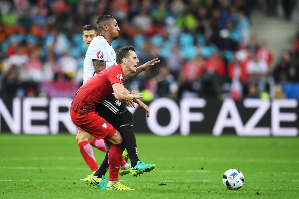 PARIS, FRANCE - JUNE 16: Jerome Boateng of Germany fouls Arkadiusz Milik of Poland resutling in an yellow card during the UEFA EURO 2016 Group C match between Germany and Poland at Stade de France on June 16, 2016 in Paris, France. (Photo by Matthias Hangst/Getty Images)