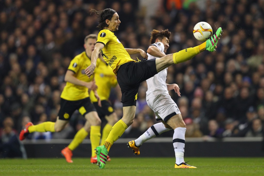 LONDON, ENGLAND - MARCH 17: Neven Subotic of Borussia Dortmund clears the ball from Son Heung-min of Tottenham Hotspur during the UEFA Europa League round of 16, second leg match between Tottenham Hotspur and Borussia Dortmund at White Hart Lane on March 17, 2016 in London, England. (Photo by Paul Gilham/Getty Images)