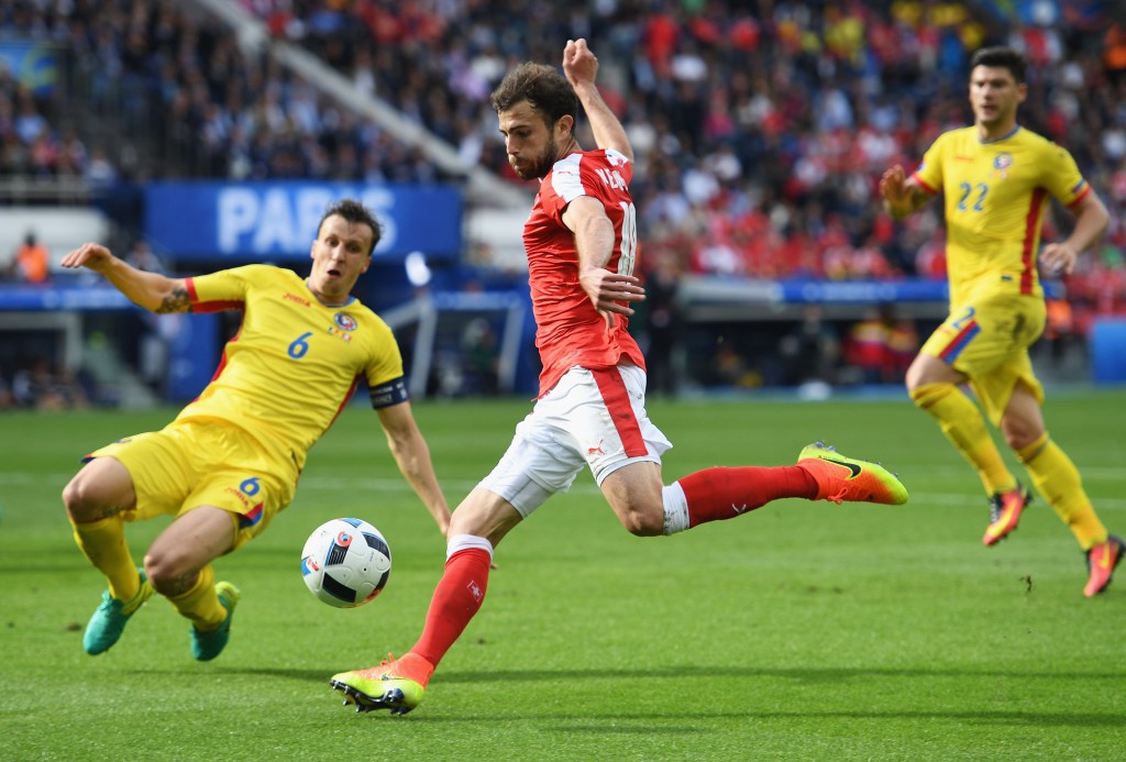 PARIS, FRANCE - JUNE 15: Admir Mehmedi of Switzerland is blocked by Vlad Chiriches of Romania during the UEFA EURO 2016 Group A match between Romania and Switzerland at Parc des Princes on June 15, 2016 in Paris, France. (Photo by Shaun Botterill/Getty Images)