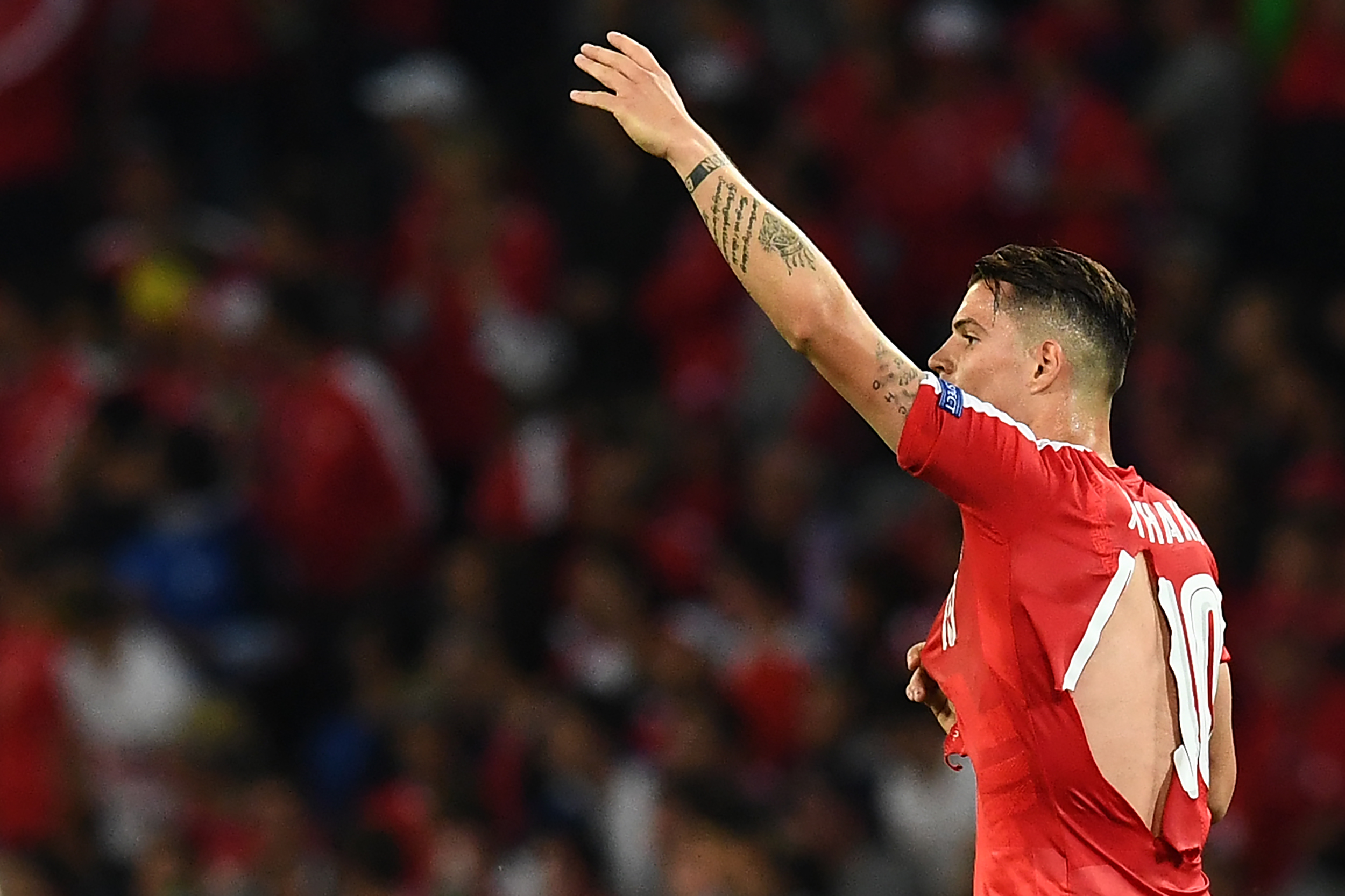 TOPSHOT - Switzerland's midfielder Granit Xhaka in a ripped shirt gestures during the Euro 2016 group A football match between Switzerland and France at the Pierre-Mauroy stadium in Lille on June 19, 2016. / AFP / FRANCK FIFE (Photo credit should read FRANCK FIFE/AFP/Getty Images)