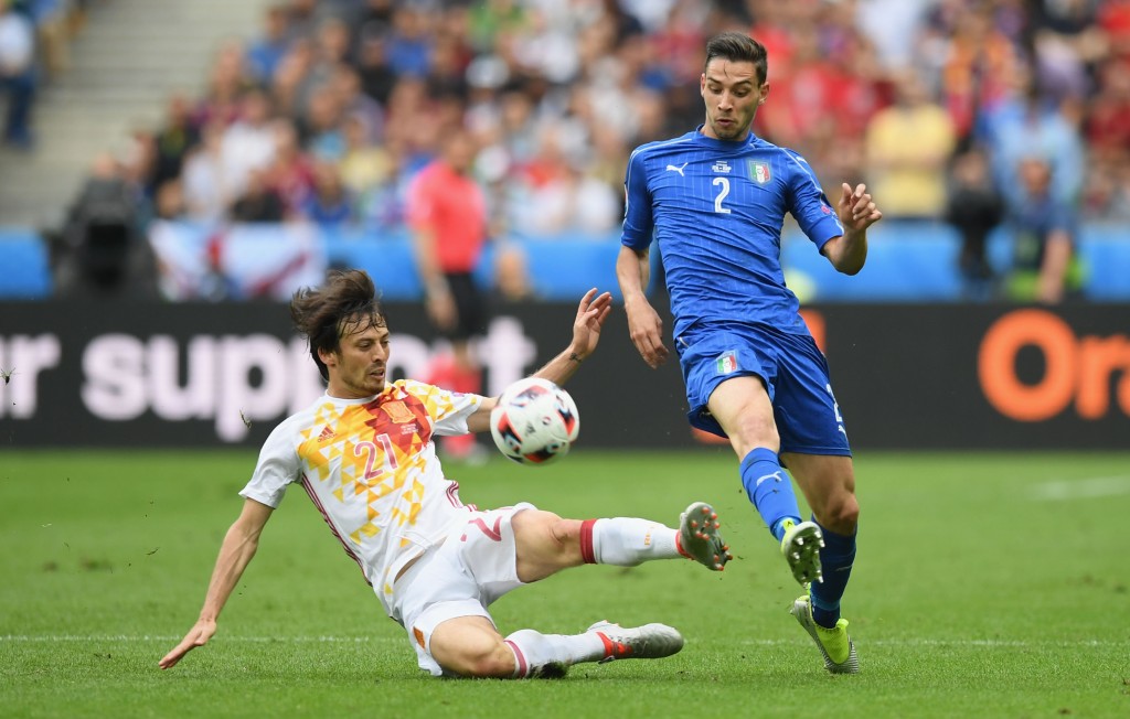 PARIS, FRANCE - JUNE 27: Mattia De Sciglio of Italy is tackled by David Silva of Spain during the UEFA EURO 2016 round of 16 match between Italy and Spain at Stade de France on June 27, 2016 in Paris, France. (Photo by Matthias Hangst/Getty Images)