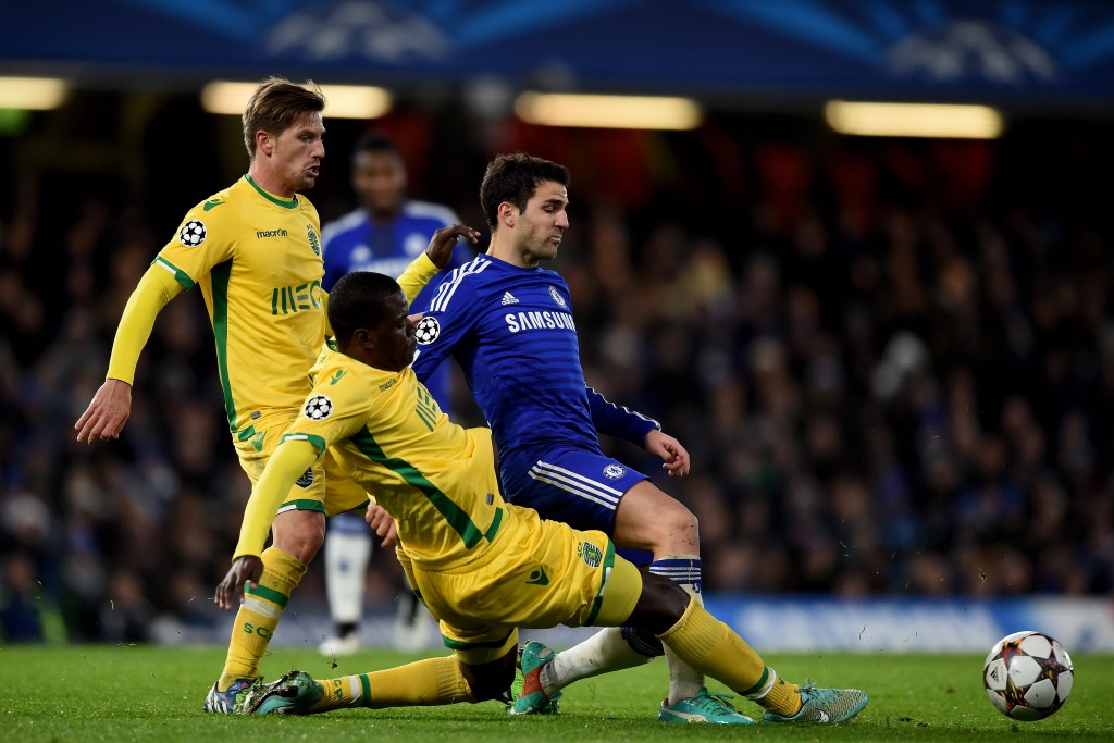 LONDON, ENGLAND - DECEMBER 10: Cesc Fabregas of Chelsea is tackled by William Carvalho of Sporting Lisbon during the UEFA Champions League group G match between Chelsea and Sporting Clube de Portugal at Stamford Bridge on December 10, 2014 in London, United Kingdom. (Photo by Paul Gilham/Getty Images)