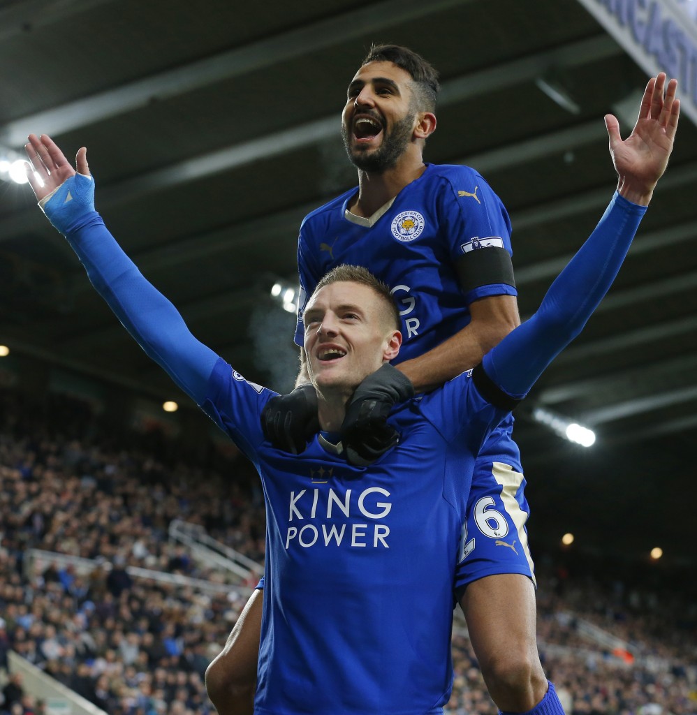 Leicester City's English striker Jamie Vardy (Below) celebrates after scoring his team's first goal with Leicester City's Algerian midfielder Riyad Mahrez during the English Premier League football match between Newcastle United and Leicester City at St James' Park in Newcastle-upon-Tyne, north east England, on November 21, 2015. / AFP / LINDSEY PARNABY (Photo credit should read LINDSEY PARNABY/AFP/Getty Images)