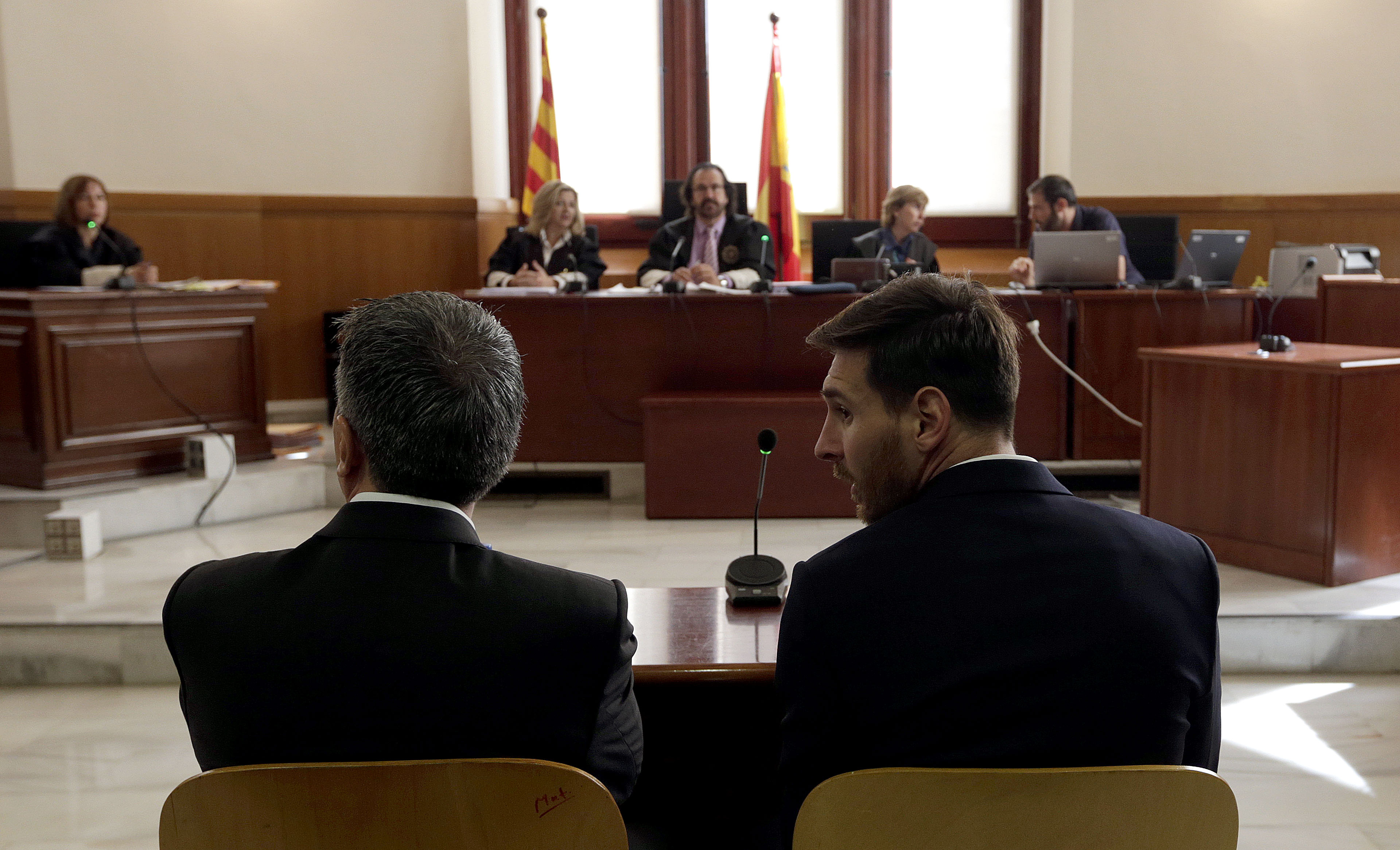 Barcelona's football star Lionel Messi (R) and his father Jorge Horacio Messi listen as they face judges in a tax fraud case at the courthouse of Barcelona on June 2, 2016.
The 28-year-old football star was cheered and jeered as he emerged from a van accompanied by his father Jorge Horacio Messi. The two are accused of using a chain of fake companies in Belize and Uruguay to avoid paying taxes on 4.16 million euros ($4.6 million) of Messi's income earned through the sale of his image rights from 2007-09. AFP PHOTO/ POOL/ ALBERTO ESTEVEZ / AFP / POOL / Alberto Estevez        (Photo credit should read ALBERTO ESTEVEZ/AFP/Getty Images)