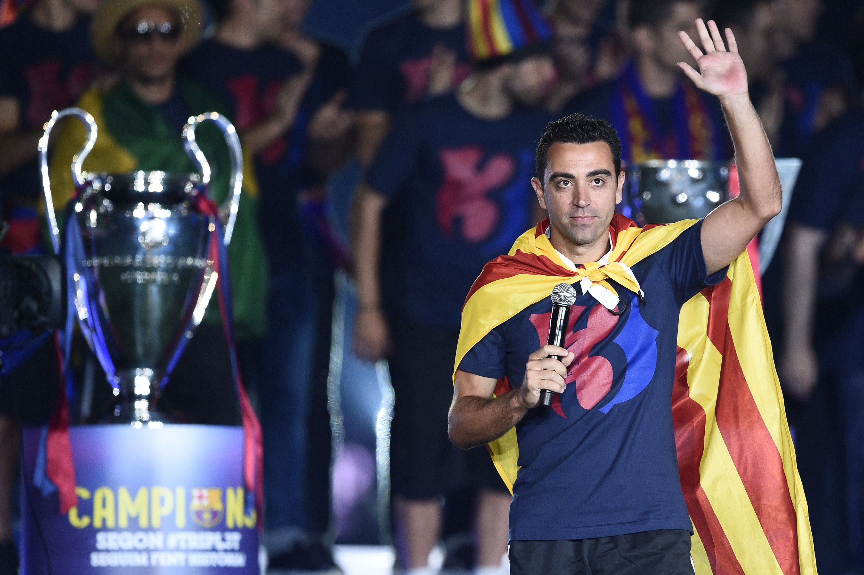 Barcelona's midfielder Xavi Hernandez waves as he takes part in the celebrations held for their victory over Juventus, one day after the UEFA Champions League final football, at the Camp Nou stadium in Barcelona on June 7, 2015. Luis Suarez and Neymar scored second-half goals to give Barcelona a 3-1 Champions League final victory over Juventus on June 6, 2015 as the Spaniards became the first team to twice win the European treble. AFP PHOTO/ JOSEP LAGO (Photo credit should read JOSEP LAGO/AFP/Getty Images)