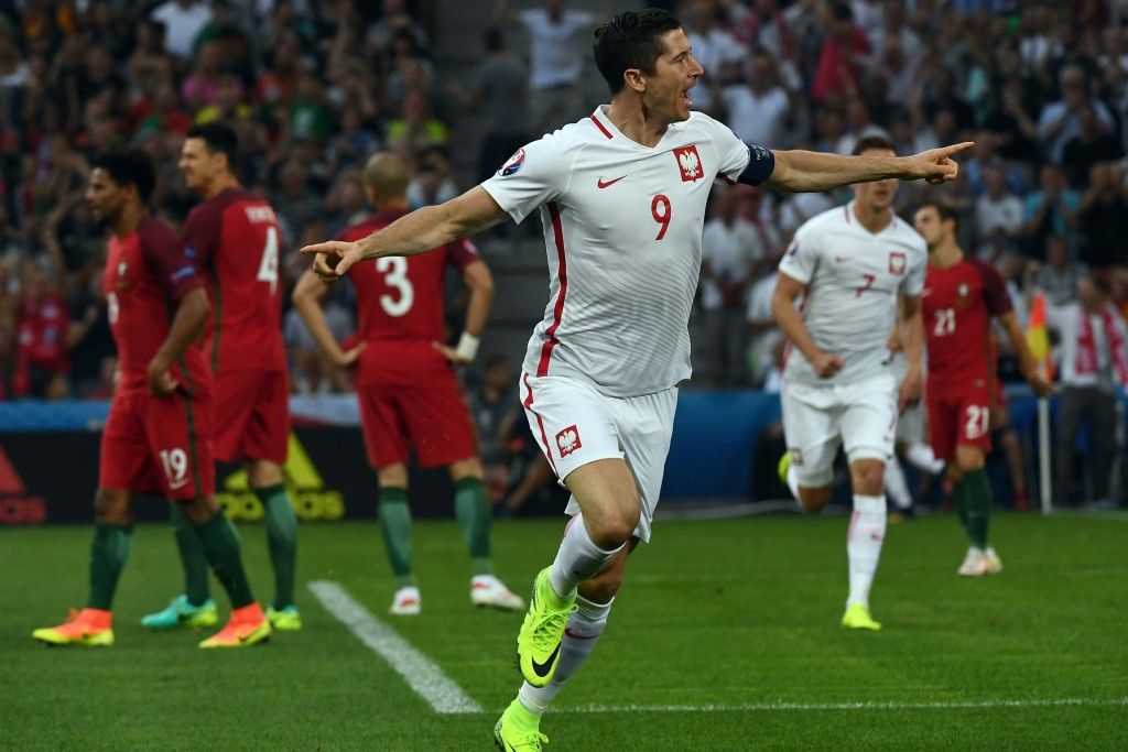 Poland's forward Robert Lewandowski celebrates after scoring the first goal during the Euro 2016 quarter-final football match between Poland and Portugal at the Stade Velodrome in Marseille on June 30, 2016. / AFP / ANNE-CHRISTINE POUJOULAT (Photo credit should read ANNE-CHRISTINE POUJOULAT/AFP/Getty Images)