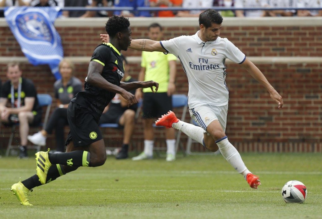 Real Madrid forward Alvaro Borja Morata Martin (R) takes a shot on goal as Chelsea defender Ola Aina (L) defends during an International Champions Cup soccer match in Ann Arbor, Michigan on July 30, 2016. / AFP / Jay LaPrete (Photo credit should read JAY LAPRETE/AFP/Getty Images)