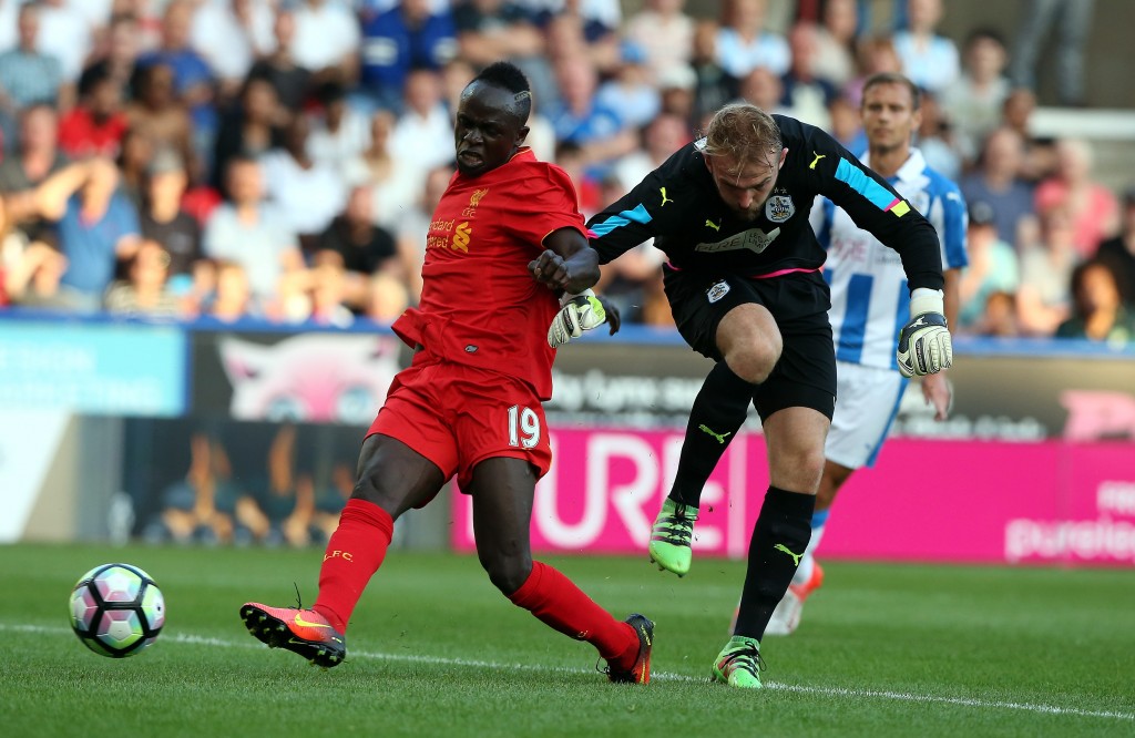 HUDDERSFIELD, ENGLAND - JULY 20: Joel Coleman(R) of Huddersfield Town challenged by Sadio Mane of Liverpool during the Pre-Season Friendly match between Huddersfield Town and Liverpool at the Galpharm Stadium on July 20, 2016 in Huddersfield, England. (Photo by Nigel Roddis/Getty Images)