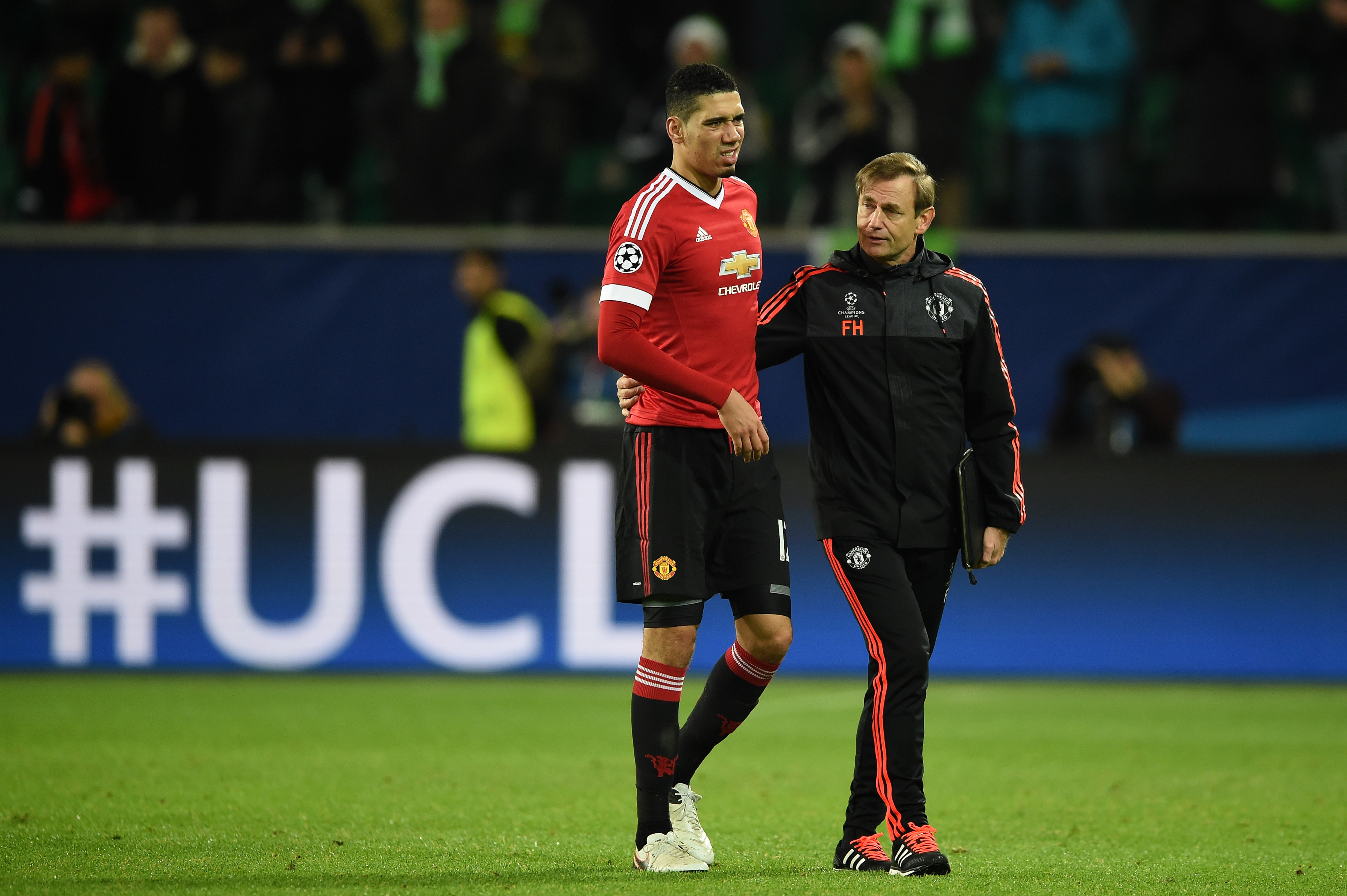 WOLFSBURG, GERMANY - DECEMBER 08: A dejected Chris Smalling the captain of Manchester United walks off the pitch following hjis team's 3-2 defeat and exit from the competition during the UEFA Champions League group B match between VfL Wolfsburg and Manchester United at the Volkswagen Arena on December 8, 2015 in Wolfsburg, Germany. (Photo by Stuart Franklin/Bongarts/Getty Images)
