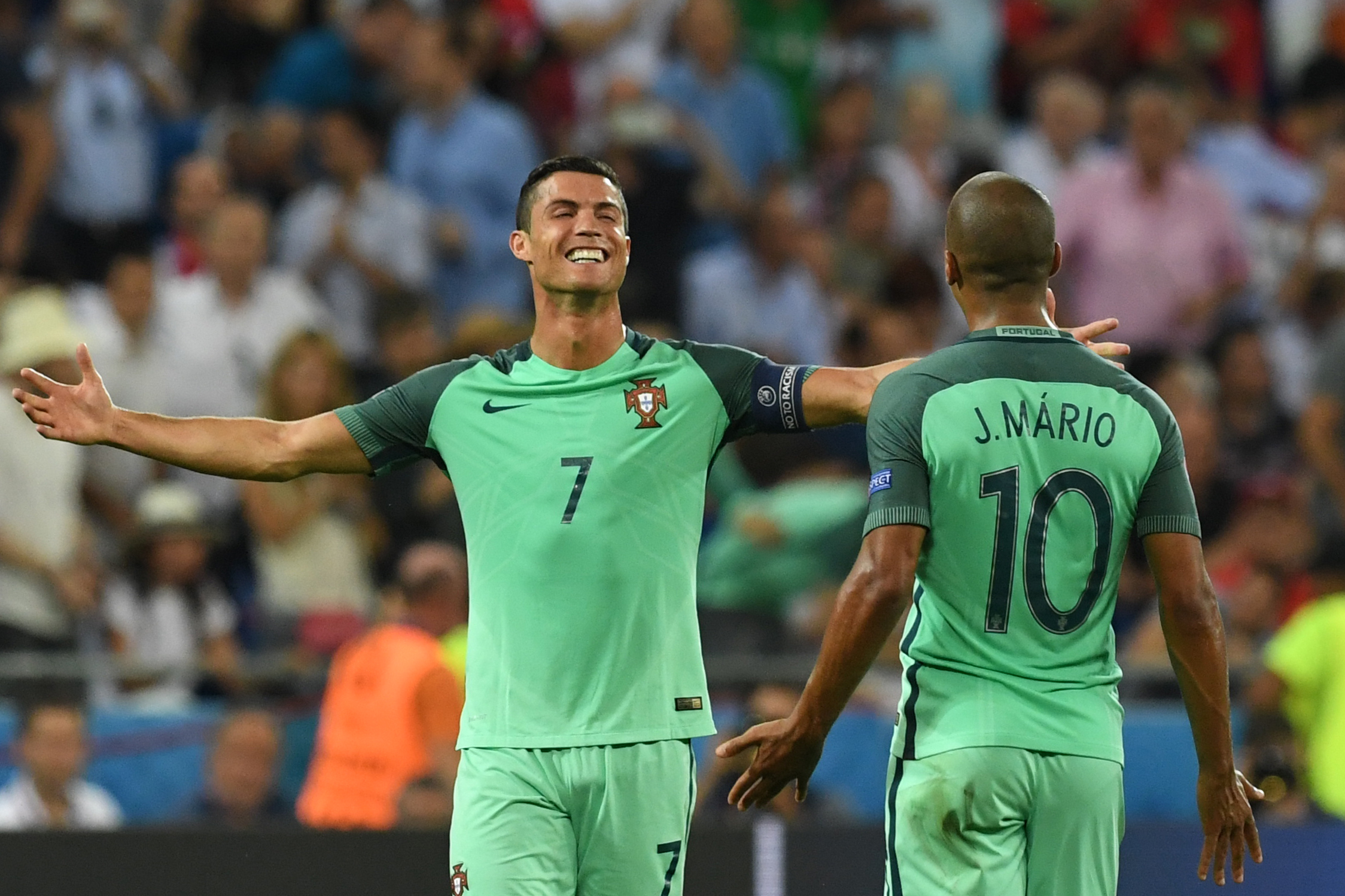 Portugal's forward Cristiano Ronaldo (L) celebrates at the end of the Euro 2016 semi-final football match between Portugal and Wales at the Parc Olympique Lyonnais stadium in Décines-Charpieu, near Lyon, on July 6, 2016.
 / AFP / Francisco LEONG        (Photo credit should read FRANCISCO LEONG/AFP/Getty Images)