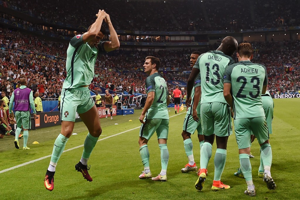 Portugal's forward Cristiano Ronaldo (L) celebrates after scoring a goal during the Euro 2016 semi-final football match between Portugal and Wales at the Parc Olympique Lyonnais stadium in Décines-Charpieu, near Lyon, on July 6, 2016. / AFP / PAUL ELLIS (Photo credit should read PAUL ELLIS/AFP/Getty Images)