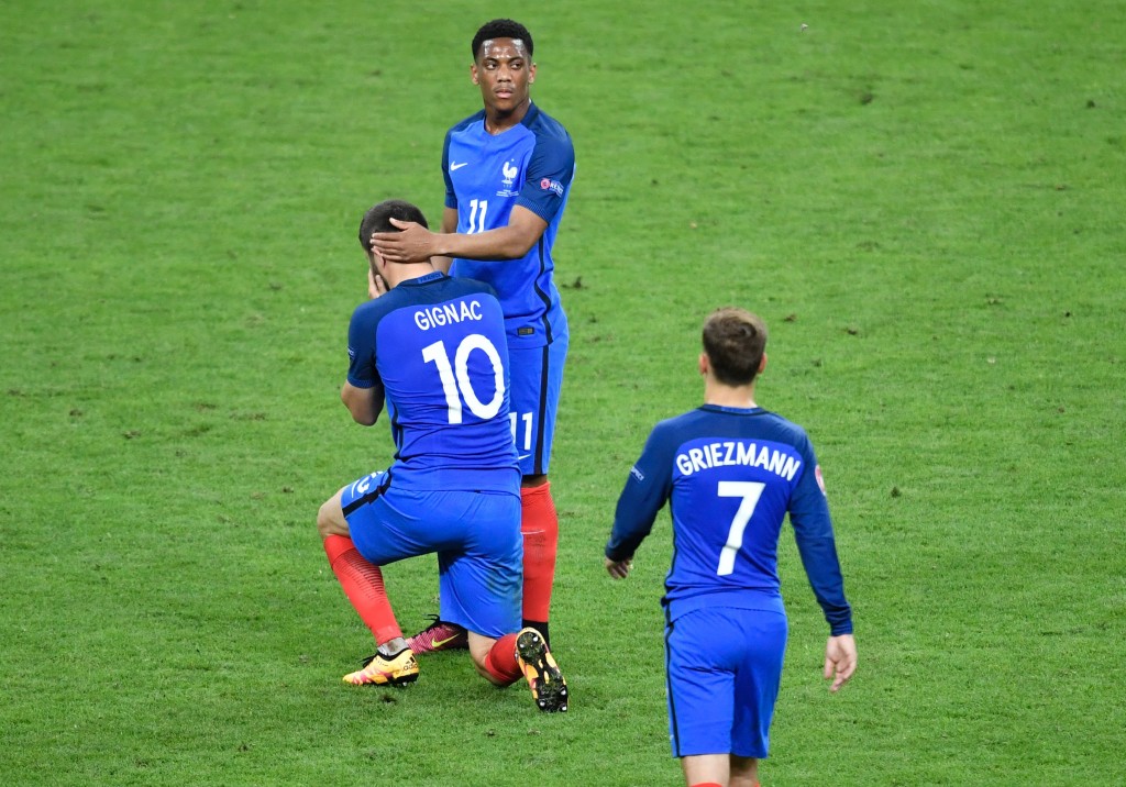 TOPSHOT - (LtoR) France's forward Andre-Pierre Gignac, France's forward Anthony Martial and France's forward Antoine Griezmann react after their team's defeat in the Euro 2016 final football match between Portugal and France at the Stade de France in Saint-Denis, north of Paris, on July 10, 2016. / AFP / PHILIPPE LOPEZ (Photo credit should read PHILIPPE LOPEZ/AFP/Getty Images)