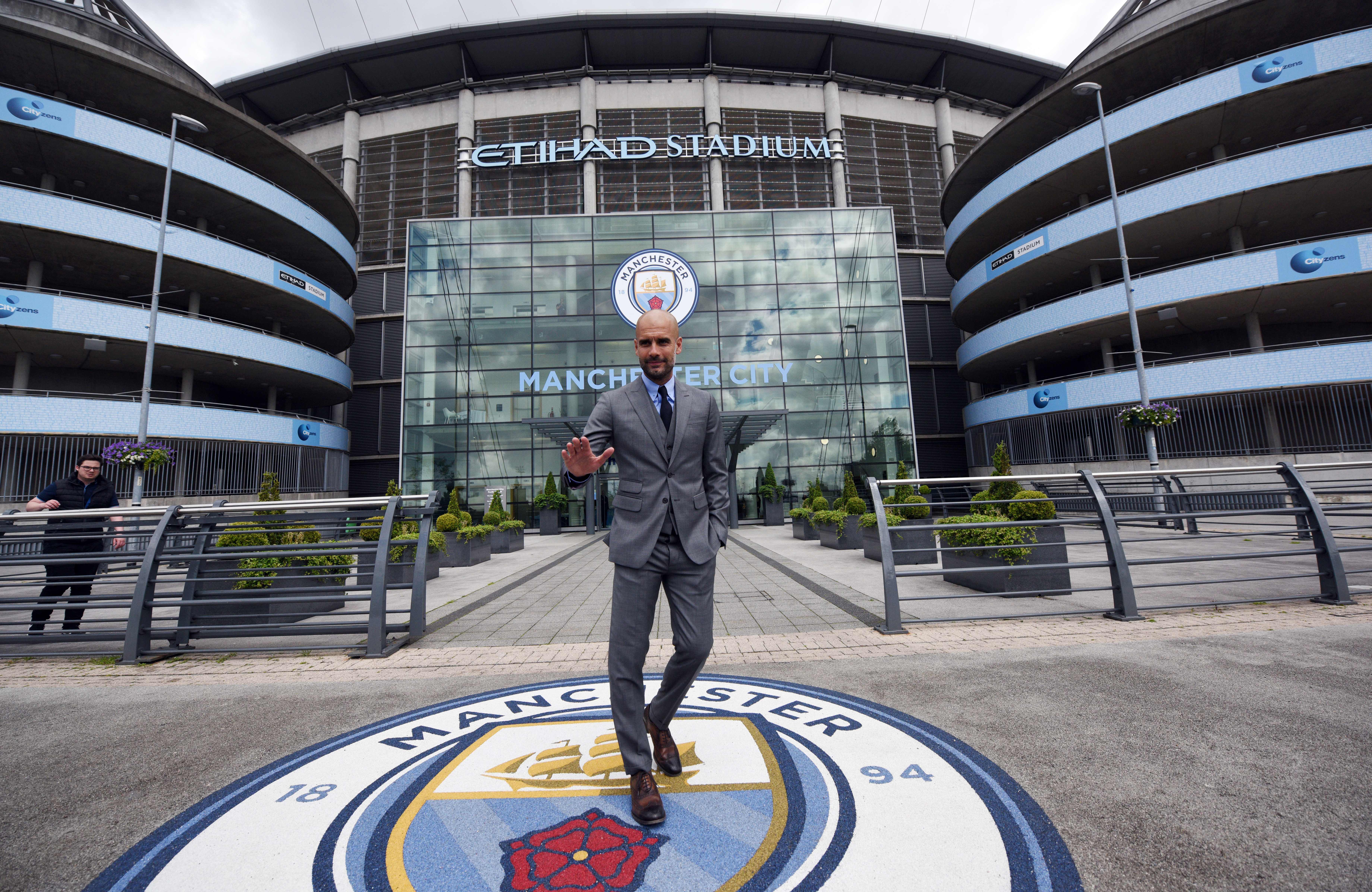 Manchester City's Spanish football coach Pep Guardiola poses for photographs outside the Etihad Stadium in Manchester, northern England, on July 8, 2016.
Pep Guardiola has warned his Manchester City players that they have to prove themselves all over again following his arrival at the club. / AFP / OLI SCARFF / RESTRICTED TO EDITORIAL USE. NO USE WITH UNAUTHORIZED AUDIO, VIDEO, DATA, FIXTURE LISTS, CLUB/LEAGUE LOGOS OR "LIVE" SERVICES. ONLINE IN-MATCH USE LIMITED TO 45 IMAGES, NO VIDEO EMULATION. NO USE IN BETTING, GAMES OR SINGLE CLUB/LEAGUE/PLAYER PUBLICATIONS. (Photo credit should read OLI SCARFF/AFP/Getty Images)