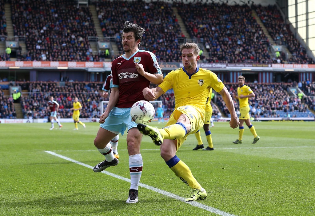 BURNLEY, ENGLAND - APRIL 09: Charlie Taylor of Leeds clears the ball from Joey Barton of Burnley during the Sky Bet Championship match between Burnley and Leeds United at Turf Moor on April 9, 2016 in Burnley, United Kingdom. (Photo by Jan Kruger/Getty Images)