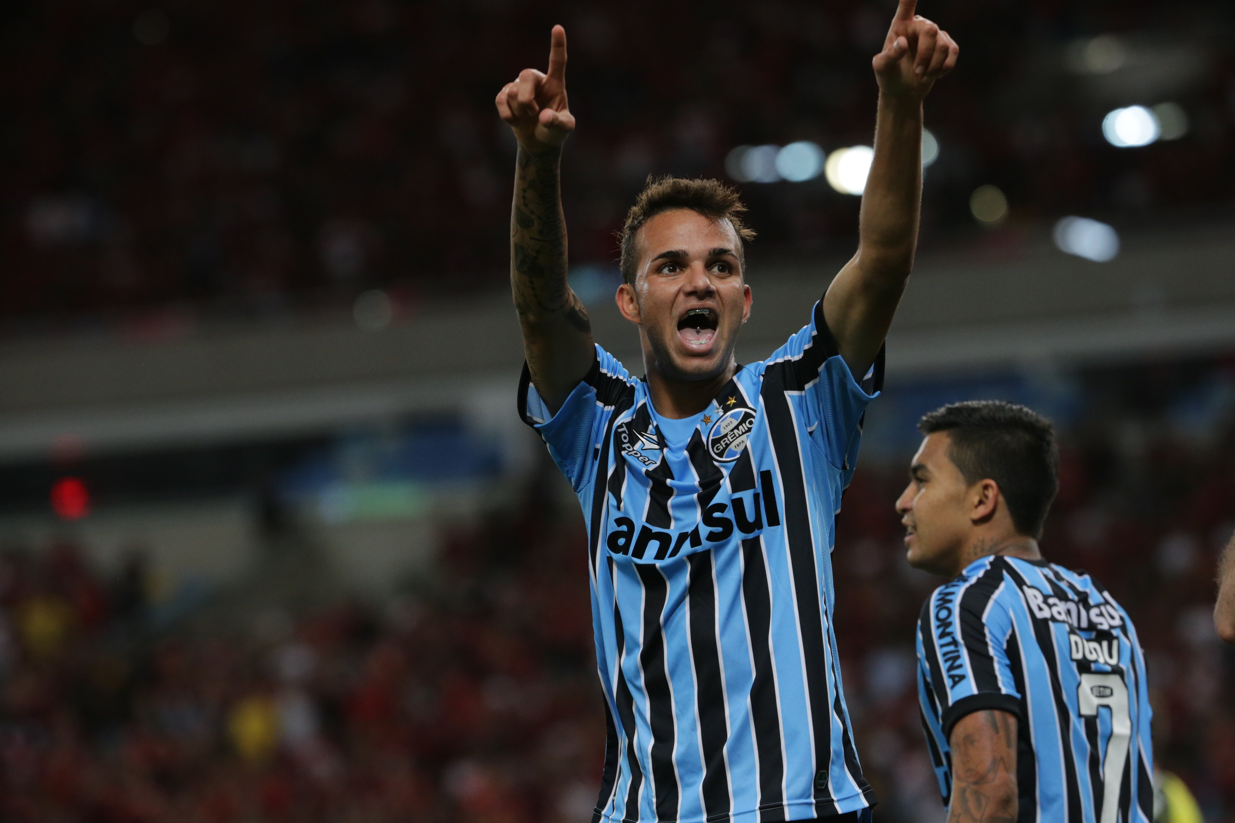 Luan (L) of Gremio celebrates after his goal against Flamengo during their Brazilian championship match at Maracana stadium in Rio de Janeiro, Brazil, on September 6, 2014. AFP PHOTO / YASUYOSHI CHIBA (Photo credit should read YASUYOSHI CHIBA/AFP/Getty Images)