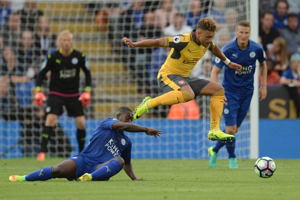 Arsenal's English midfielder Alex Oxlade-Chamberlain (C) jumps a challenge from Leicester City's French midfielder Nampalys Mendy (L) during the English Premier League football match between Leicester City and Arsenal at King Power Stadium in Leicester, central England on August 20, 2016. (Photo credit: Oli Scarff/AFP/Getty Images)