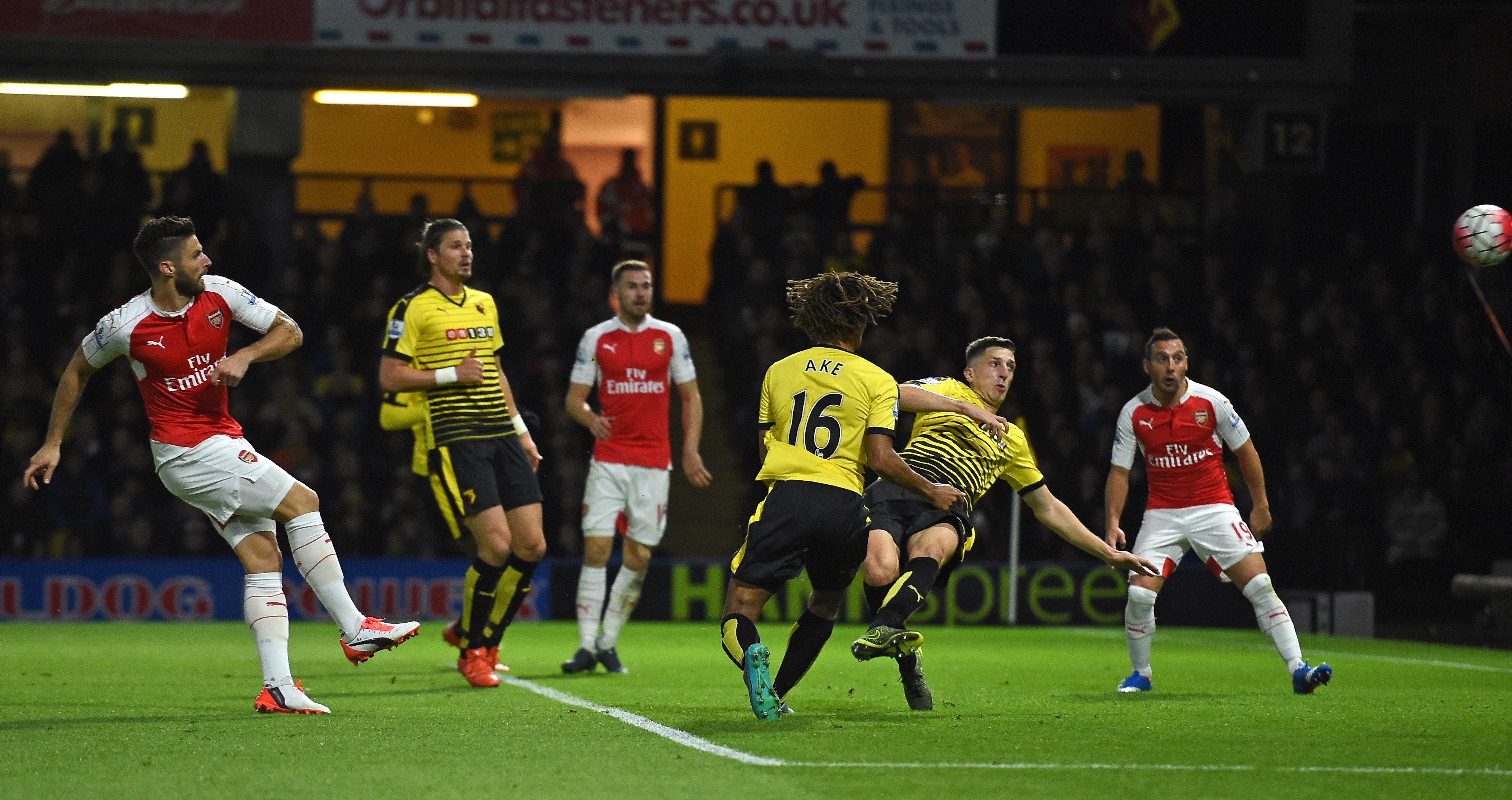 Arsenal's French striker Olivier Giroud (L) shoots to score their second goal during the English Premier League football match between Watford and Arsenal at Vicarage Road Stadium in Watford, north of London on October 17, 2015. AFP PHOTO / PAUL ELLIS
RESTRICTED TO EDITORIAL USE. No use with unauthorized audio, video, data, fixture lists, club/league logos or 'live' services. Online in-match use limited to 75 images, no video emulation. No use in betting, games or single club/league/player publications. (Photo credit should read PAUL ELLIS/AFP/Getty Images)