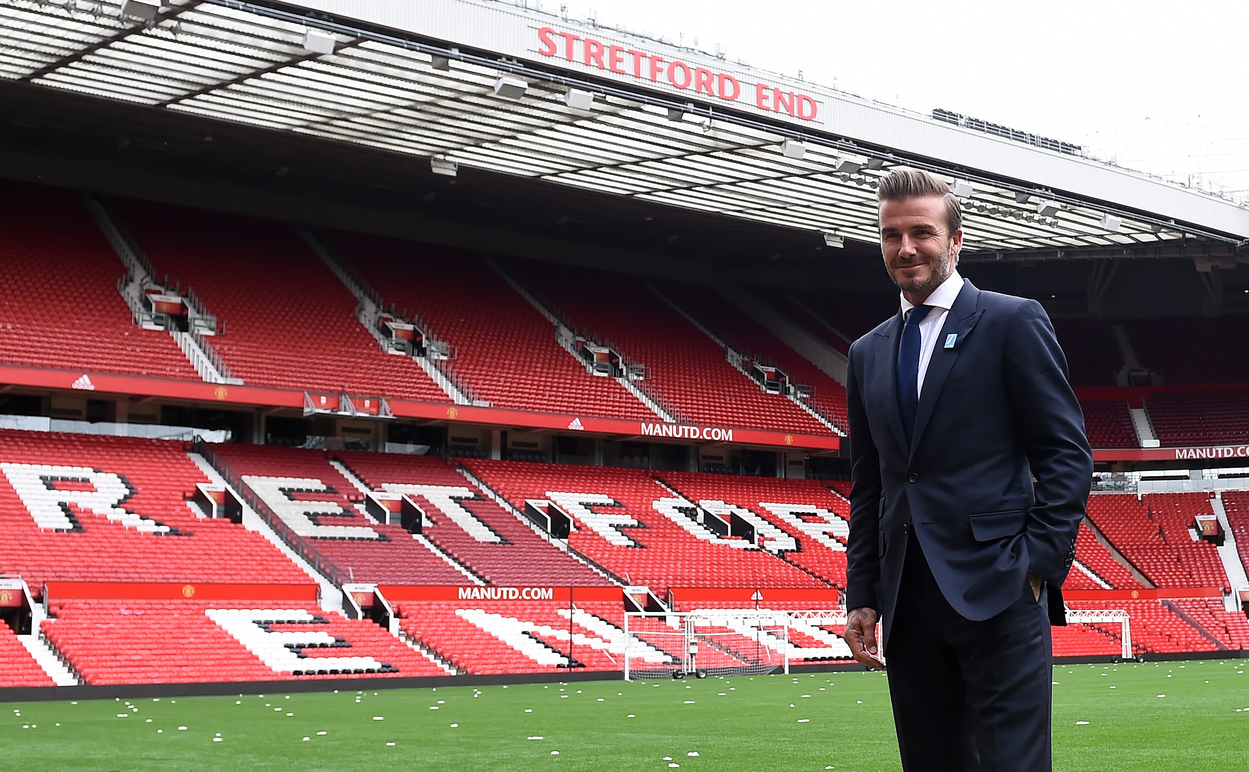 Former Manchester United and England footballer David Beckham poses on the pitch at Old Trafford in Manchester, north west England on October 6, 2015 ahead of a charity football match in aid of UNICEF. Beckham will lead the Great Britain and Ireland team against a Rest of the World team led by Zinedine Zidane at Old Trafford on November 14.
AFP PHOTO/PAUL ELLIS (Photo credit should read PAUL ELLIS/AFP/Getty Images)