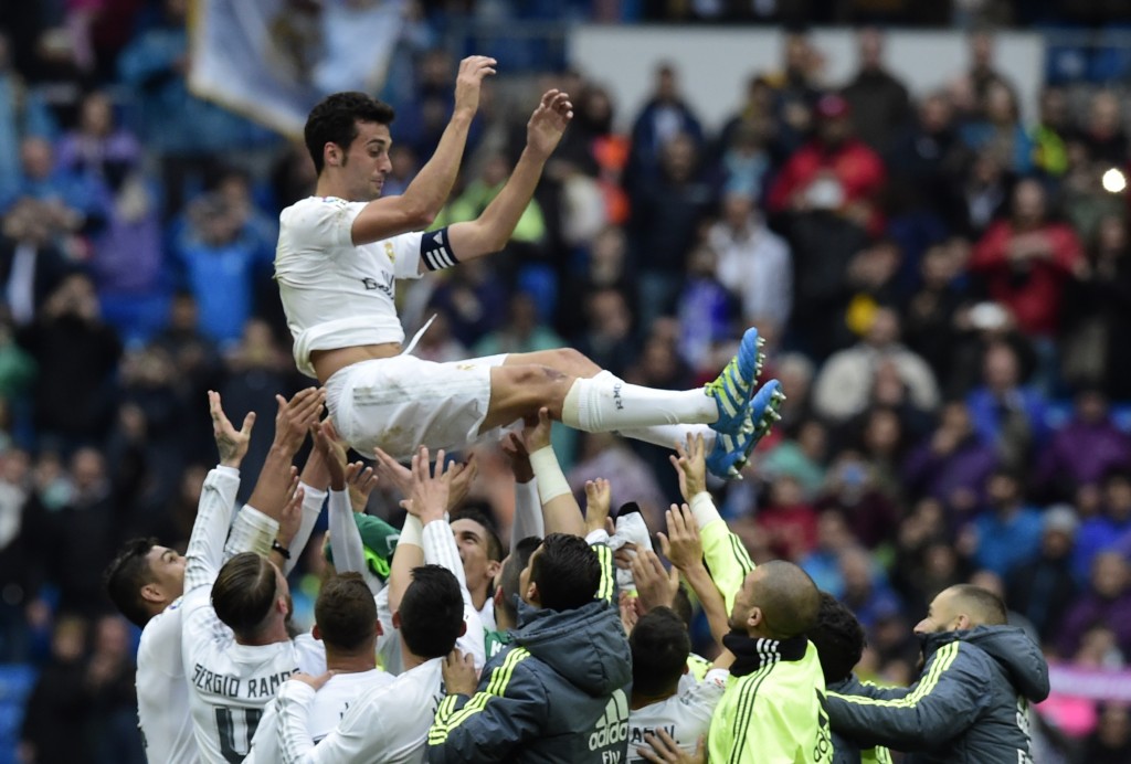Real Madrid's defender Alvaro Arbeloa (up) celebrates with his teammates his last match for Real Madrid after the Spanish league football match Real Madrid CF vs Valencia CF at the Santiago Bernabeu stadium in Madrid on May 8, 2016. (Photo credit: Javier Soriano/AFP/Getty Images)