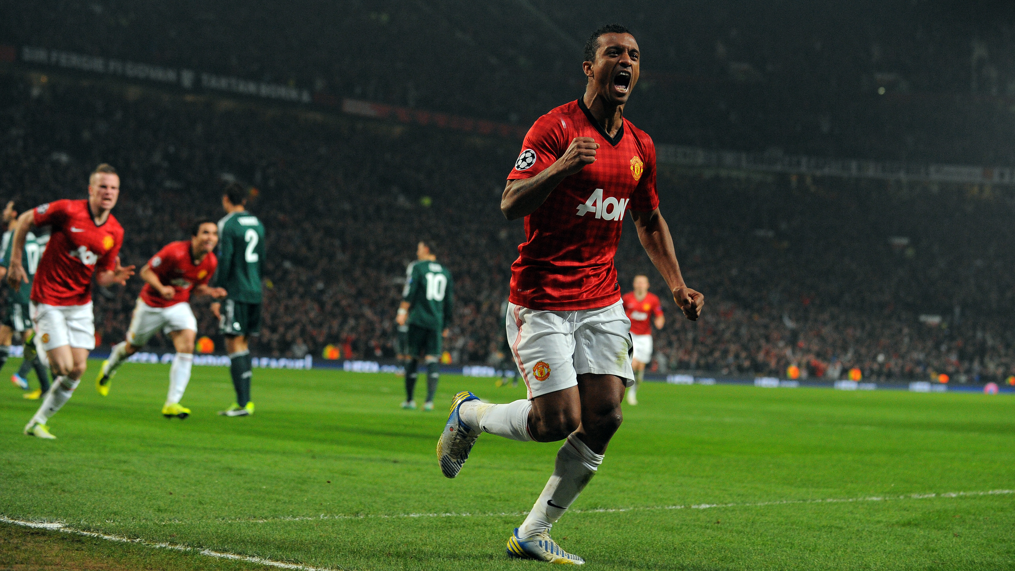 Manchester United's Portuguese midfielder Nani celebrates after Real Madrid's Spanish defender Sergio Ramos (unseen) scored an own goal during the UEFA Champions League round of 16 second leg football match between Manchester United and Real Madrid at Old Trafford in Manchester, northwest England on March 5, 2013. AFP PHOTO / ANDREW YATES (Photo credit should read ANDREW YATES/AFP/Getty Images)