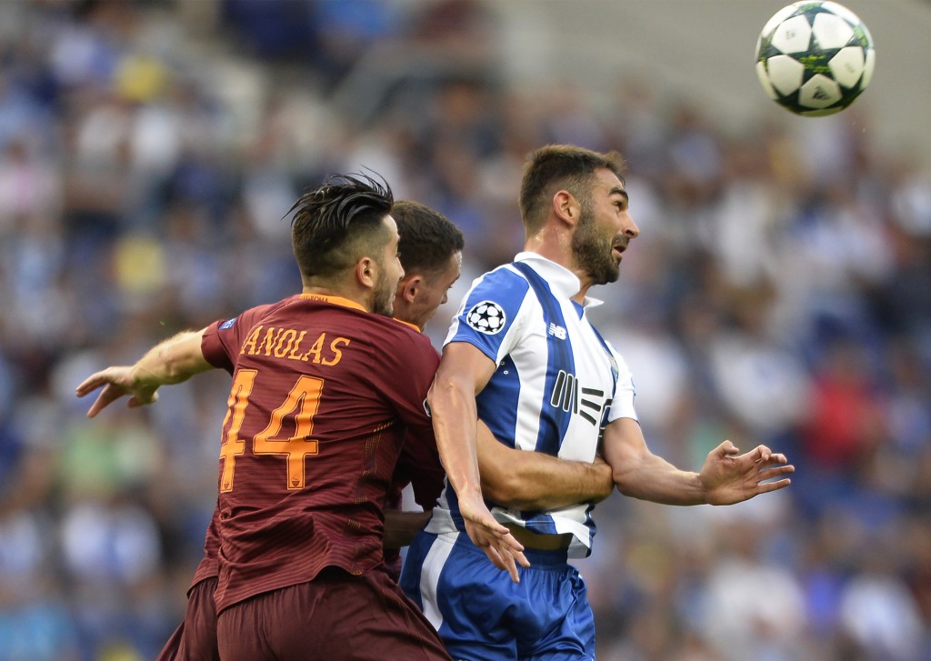 AS Roma's Greek defender Kostas Manolas (L) vies with Porto's Spanish forward Adrian Lopez during the UEFA Champions League first leg play off football match FC Porto vs AS Roma at the Dragao stadium in Porto on August 17, 2016. / AFP / MIGUEL RIOPA (Photo credit should read MIGUEL RIOPA/AFP/Getty Images)
