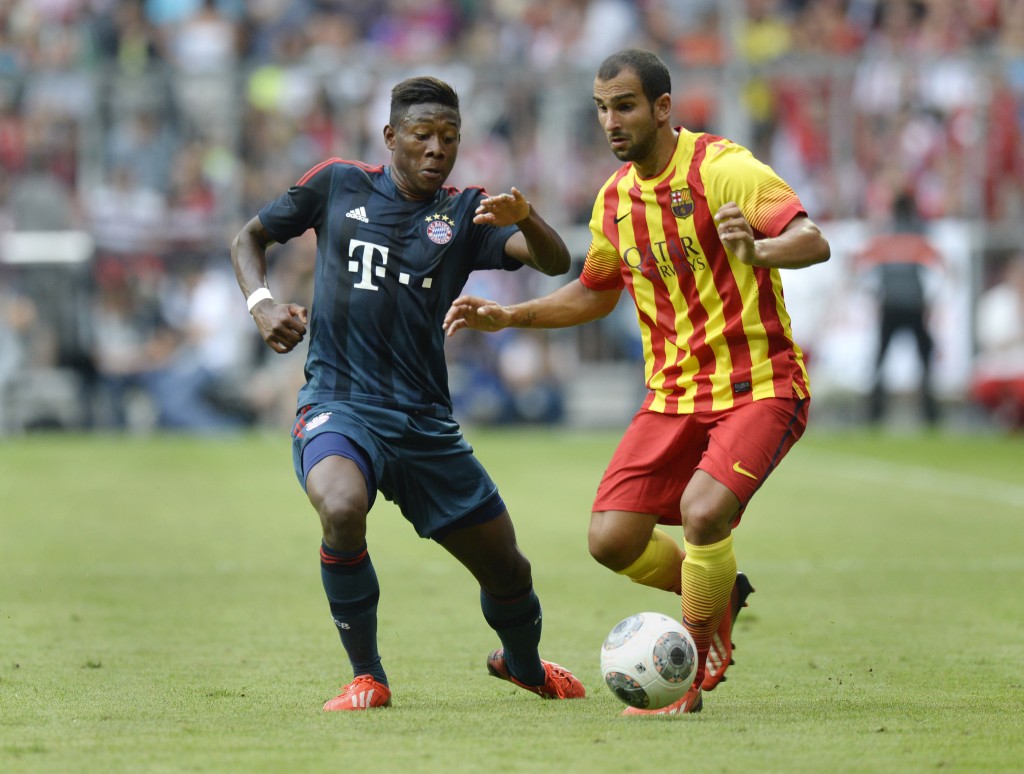 Bayern Munich's Austrian midfielder David Alaba (L) and Barcelona's defender Martin Montoya vie for the ball during the "Uli Hoeness Cup" friendly football match FC Bayern Munich vs FC Barcelona in the stadium in Munich, southern Germany, on July 24, 2013. AFP PHOTO/CHRISTOF STACHE (Photo credit should read CHRISTOF STACHE/AFP/Getty Images)