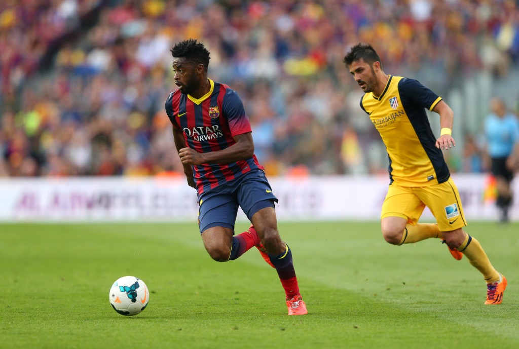 BARCELONA, SPAIN - MAY 17: Alex Song of FC Barcelona beats David Villa of Club Atletico de Madrid during the La Liga match between FC Barcelona and Club Atletico de Madrid at Camp Nou on May 17, 2014 in Barcelona, Spain. (Photo by Alex Livesey/Getty Images)