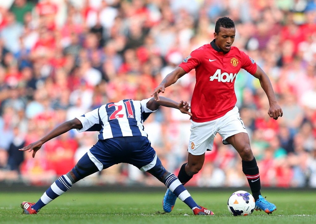 MANCHESTER, ENGLAND - SEPTEMBER 28: Nani of Manchester United beats Youssouf Mulumbu of West Bromwich Albion during the Barclays Premier League match between Manchester United and West Bromwich Albion at Old Trafford on September 28, 2013 in Manchester, England. (Photo by Alex Livesey/Getty Images)
