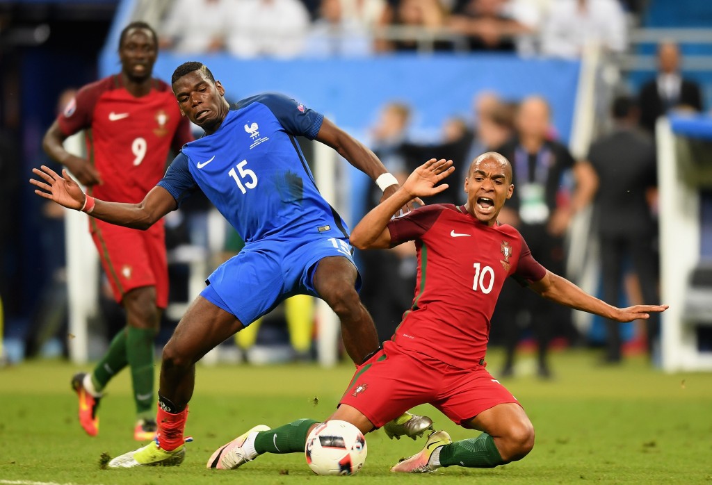 PARIS, FRANCE - JULY 10: Joao Mario of Portugal and Paul Pogba of France compete for the ball during the UEFA EURO 2016 Final match between Portugal and France at Stade de France on July 10, 2016 in Paris, France. (Photo by Michael Regan/Getty Images)
