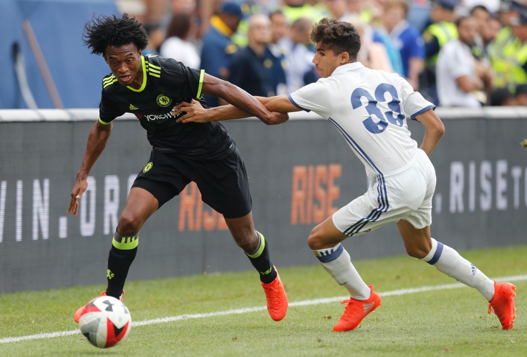 Chelsea forward Juan Cuadrado (L) kicks the ball past Real Madrid defender Achraf Hakimi (R) during an International Champions Cup soccer match in Ann Arbor, Michigan on July 30, 2016. / AFP / Jay LaPrete (Photo credit should read JAY LAPRETE/AFP/Getty Images)
