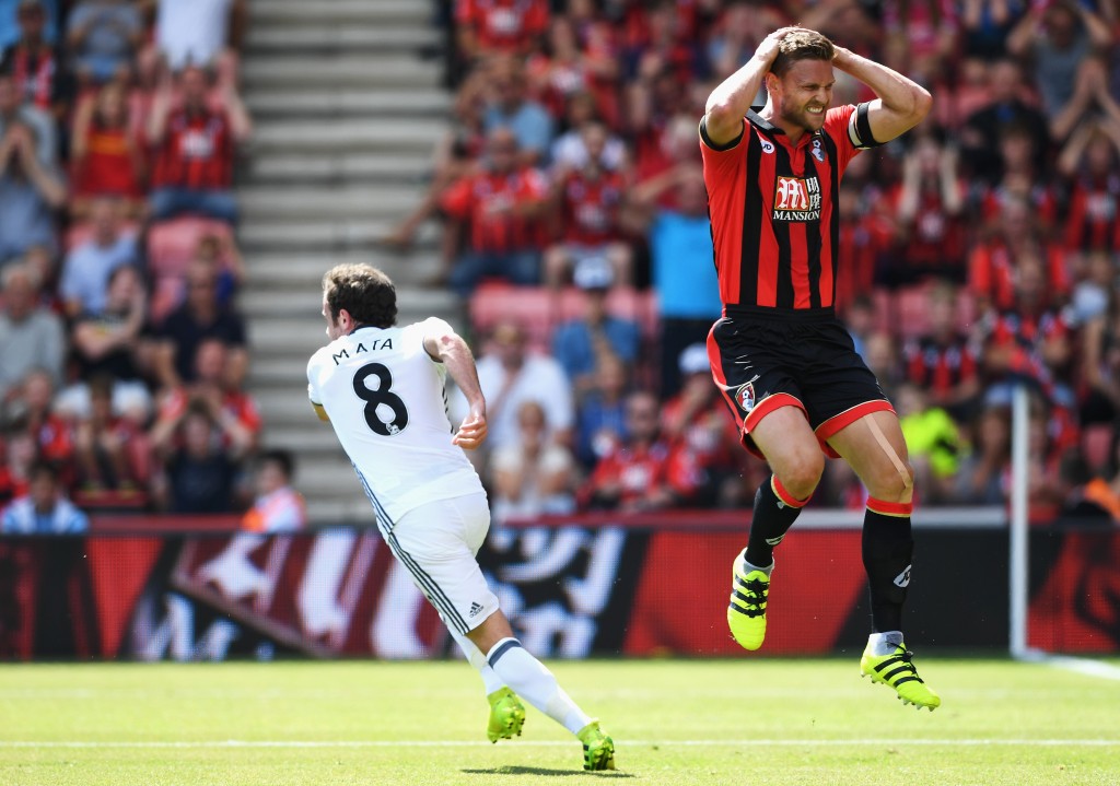 BOURNEMOUTH, ENGLAND - AUGUST 14: Juan Mata of Manchester United turns away after scoring the opening goal as Simon Francis of AFC Bournemouth reacts during the Premier League match between AFC Bournemouth and Manchester United at Vitality Stadium on August 14, 2016 in Bournemouth, England. (Photo by Stu Forster/Getty Images)