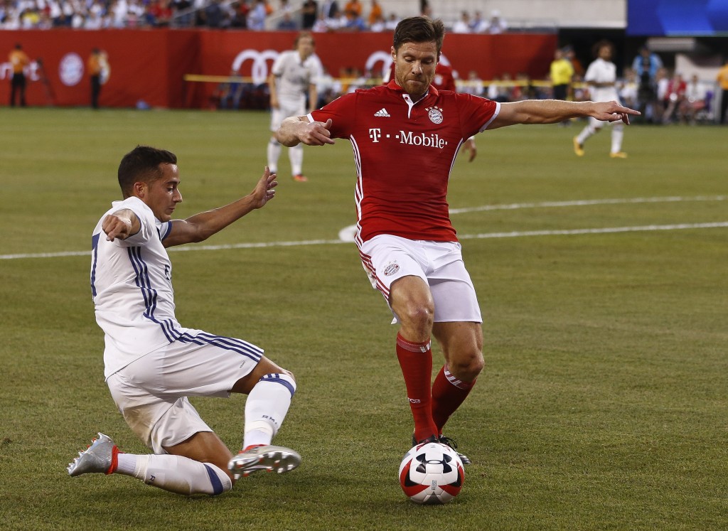 EAST RUTHERFORD, NJ - AUGUST 03: Lucas Vazquez #17 of Real Madrid guards Xabi Alonso #14 of Bayern Munich during their International Champions Cup match at MetLife Stadium on August 3, 2016 in East Rutherford, New Jersey. (Photo by Jeff Zelevansky/Getty Images)