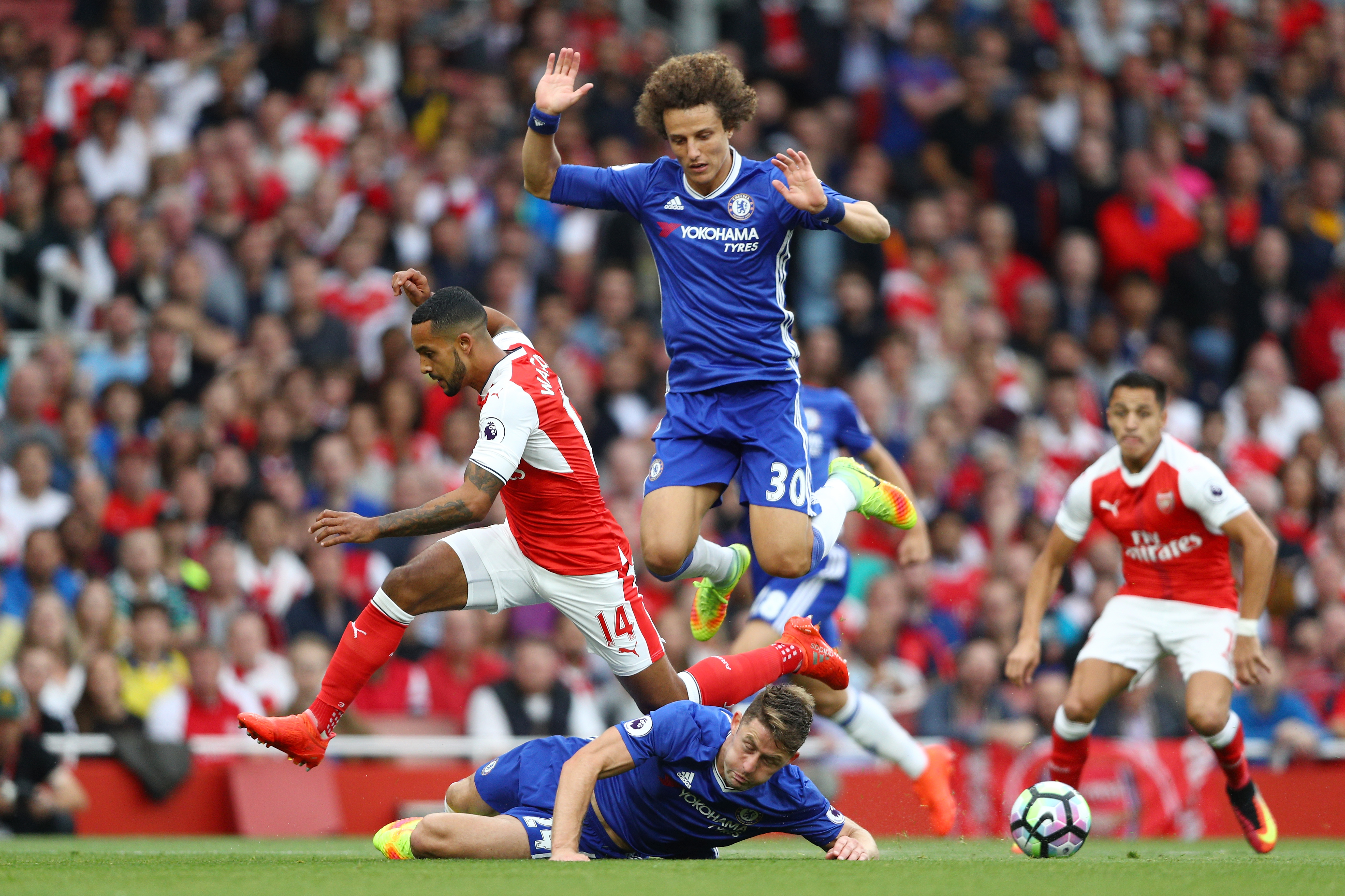 LONDON, ENGLAND - SEPTEMBER 24: Theo Walcott of Arsenal (L) is fouled by Gary Cahill of Chelsea (C) during the Premier League match between Arsenal and Chelsea at the Emirates Stadium on September 24, 2016 in London, England. (Photo by Paul Gilham/Getty Images)