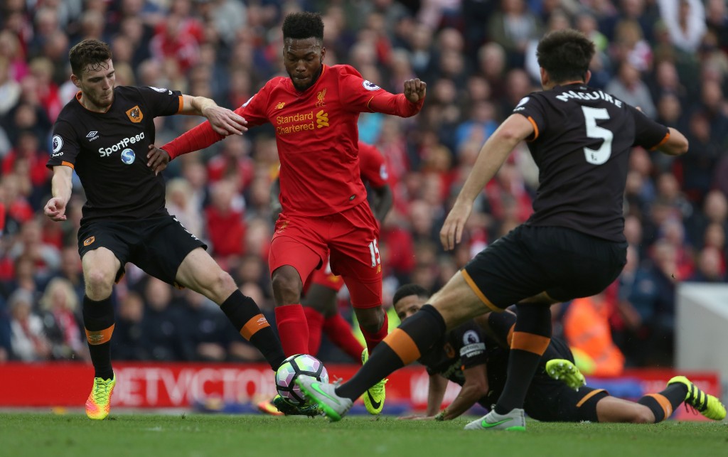 Liverpool's English striker Daniel Sturridge (C) vies with Hull City's Scottish defender Andrew Robertson (L) and Hull City's English defender Harry Maguire during the English Premier League football match between Liverpool and Hull City at Anfield in Liverpool, north west England on September 24, 2016. / AFP / Geoff CADDICK / RESTRICTED TO EDITORIAL USE. No use with unauthorized audio, video, data, fixture lists, club/league logos or 'live' services. Online in-match use limited to 75 images, no video emulation. No use in betting, games or single club/league/player publications. / (Photo credit should read GEOFF CADDICK/AFP/Getty Images)