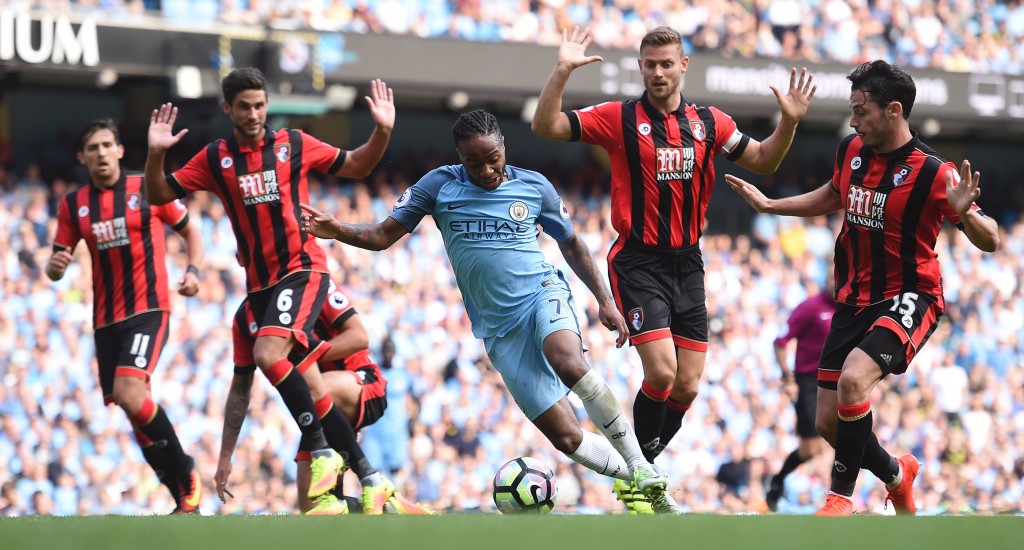 Manchester City's English midfielder Raheem Sterling (C) wriggles past Bournemouth's South African-born English midfielder Andrew Surman (2L) and Bournemouth's English defender Simon Francis (2R) during the English Premier League football match between Manchester City and Bournemouth at the Etihad Stadium in Manchester, north west England, on September 17, 2016. (Photo by Paul Ellis/AFP/Getty Images)