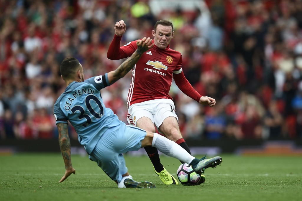 Manchester United's English striker Wayne Rooney (R) vies with Manchester City's Argentinian defender Nicolas Otamendi during the English Premier League football match between Manchester United and Manchester City at Old Trafford in Manchester, north west England, on September 10, 2016. / AFP / Oli SCARFF / RESTRICTED TO EDITORIAL USE. No use with unauthorized audio, video, data, fixture lists, club/league logos or 'live' services. Online in-match use limited to 75 images, no video emulation. No use in betting, games or single club/league/player publications. / (Photo credit should read OLI SCARFF/AFP/Getty Images)