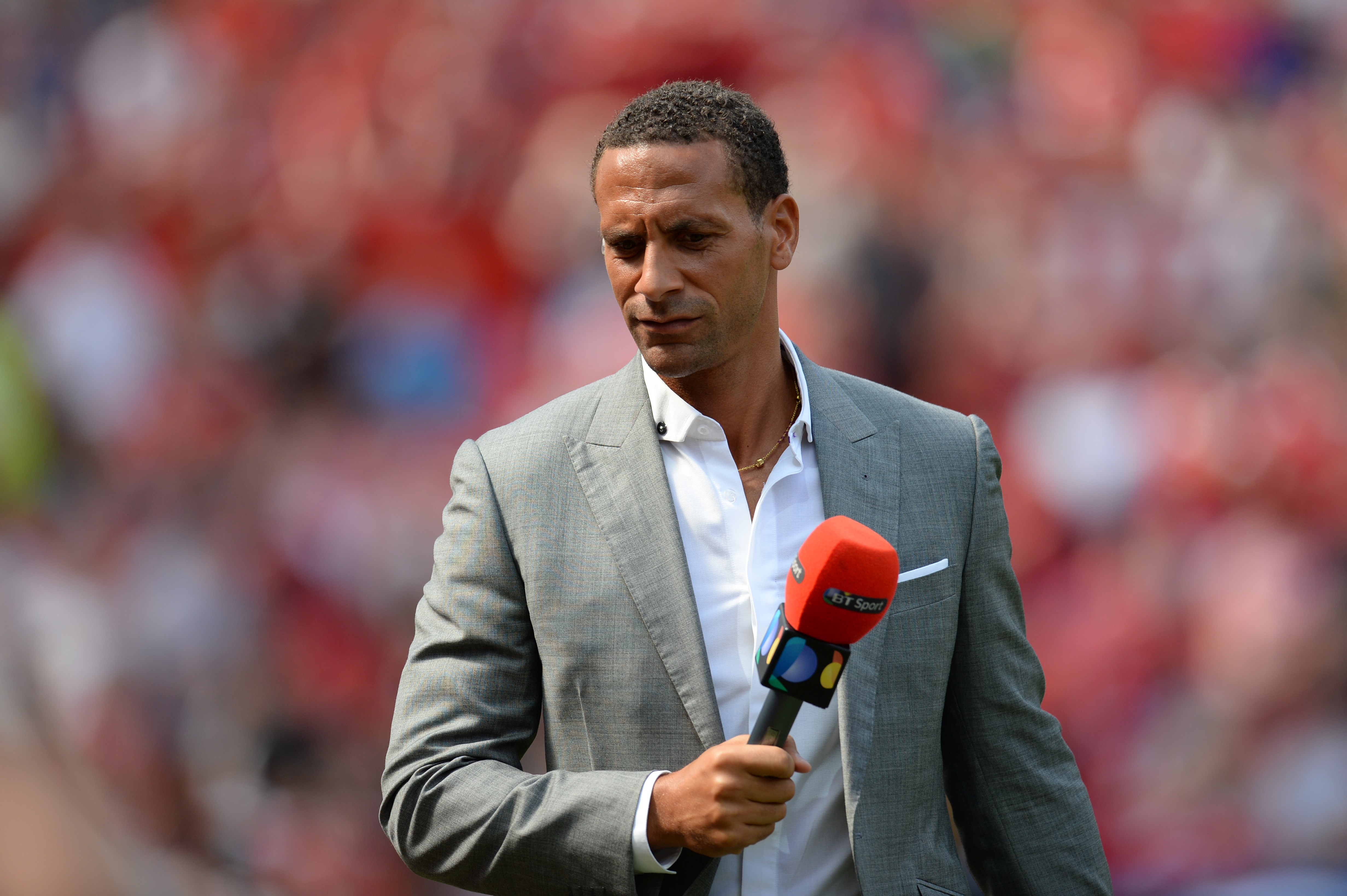 Former Manchester United defender Rio Ferdinand, working as a Television pundit is pictured ahead of the English Premier League football match between Manchester United and Tottenham Hotspur at Old Trafford in Manchester, north west England, on August 8, 2015. AFP PHOTO / OLI SCARFF
RESTRICTED TO EDITORIAL USE. No use with unauthorized audio, video, data, fixture lists, club/league logos or 'live' services. Online in-match use limited to 75 images, no video emulation. No use in betting, games or single club/league/player publications. (Photo credit should read OLI SCARFF/AFP/Getty Images)