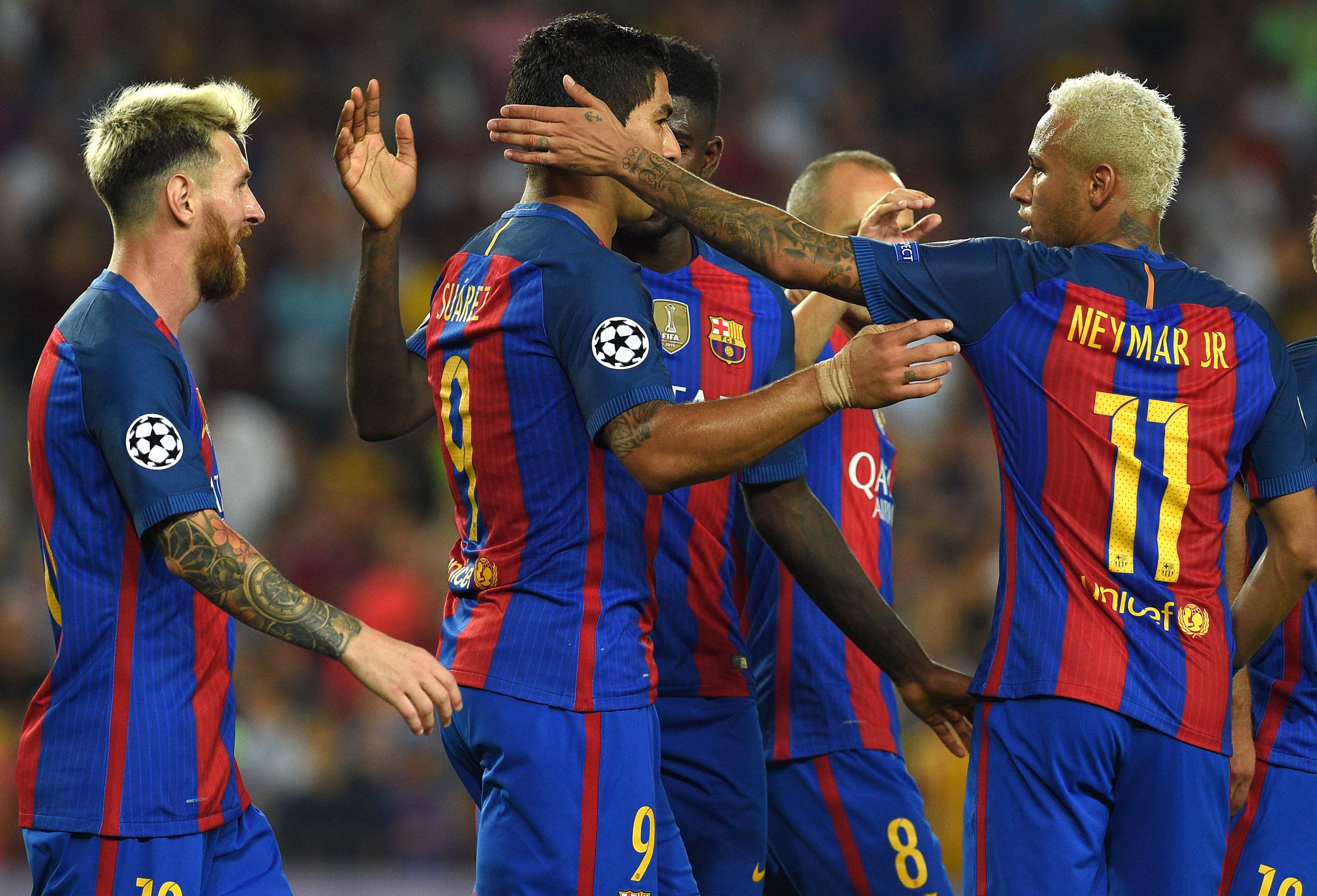 Barcelona's Uruguayan forward Luis Suarez (C) is congratulated by Barcelona's Brazilian forward Neymar (R) and Barcelona's Argentinian forward Lionel Messi (L) after scoring a goal during the UEFA Champions League football match FC Barcelona vs Celtic FC at the Camp Nou stadium in Barcelona on September 13, 2016. / AFP / LLUIS GENE (Photo credit should read LLUIS GENE/AFP/Getty Images)