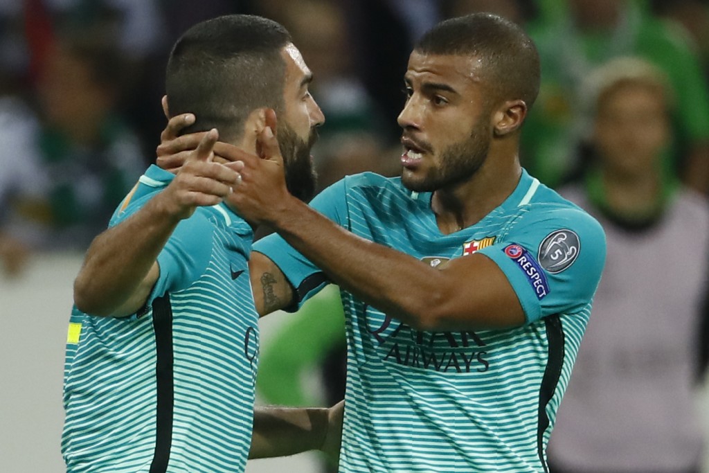 Barcelona's Turkish midfielder Arda Turan (L) celebrate after scoring the 1-1 equalizer with Barcelona's Brazilian midfielder Rafinha during the UEFA Champions League first-leg group C football match between Borussia Moenchengladbach and FC Barcelona at the Borussia Park in Moenchengladbach, western Germany on September 28, 2016. / AFP / Odd ANDERSEN (Photo credit should read ODD ANDERSEN/AFP/Getty Images)