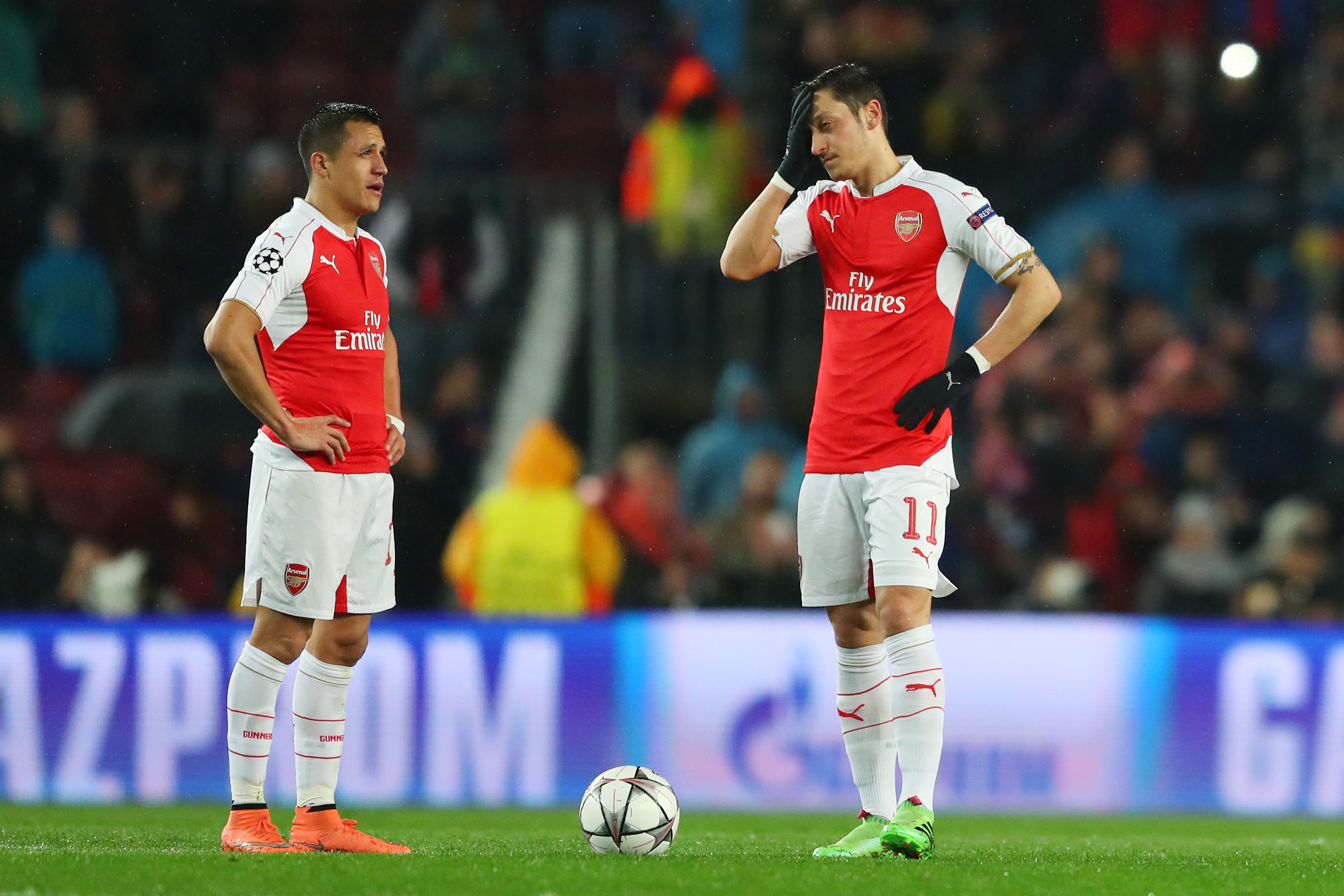 BARCELONA, SPAIN - MARCH 16: Alexis Sanchez (L) and Mesut Ozil (R) of Arsenal show their dejection after Barcelona's first goal during the UEFA Champions League round of 16, second Leg match between FC Barcelona and Arsenal FC at Camp Nou on March 16, 2016 in Barcelona, Spain. (Photo by Richard Heathcote/Getty Images)